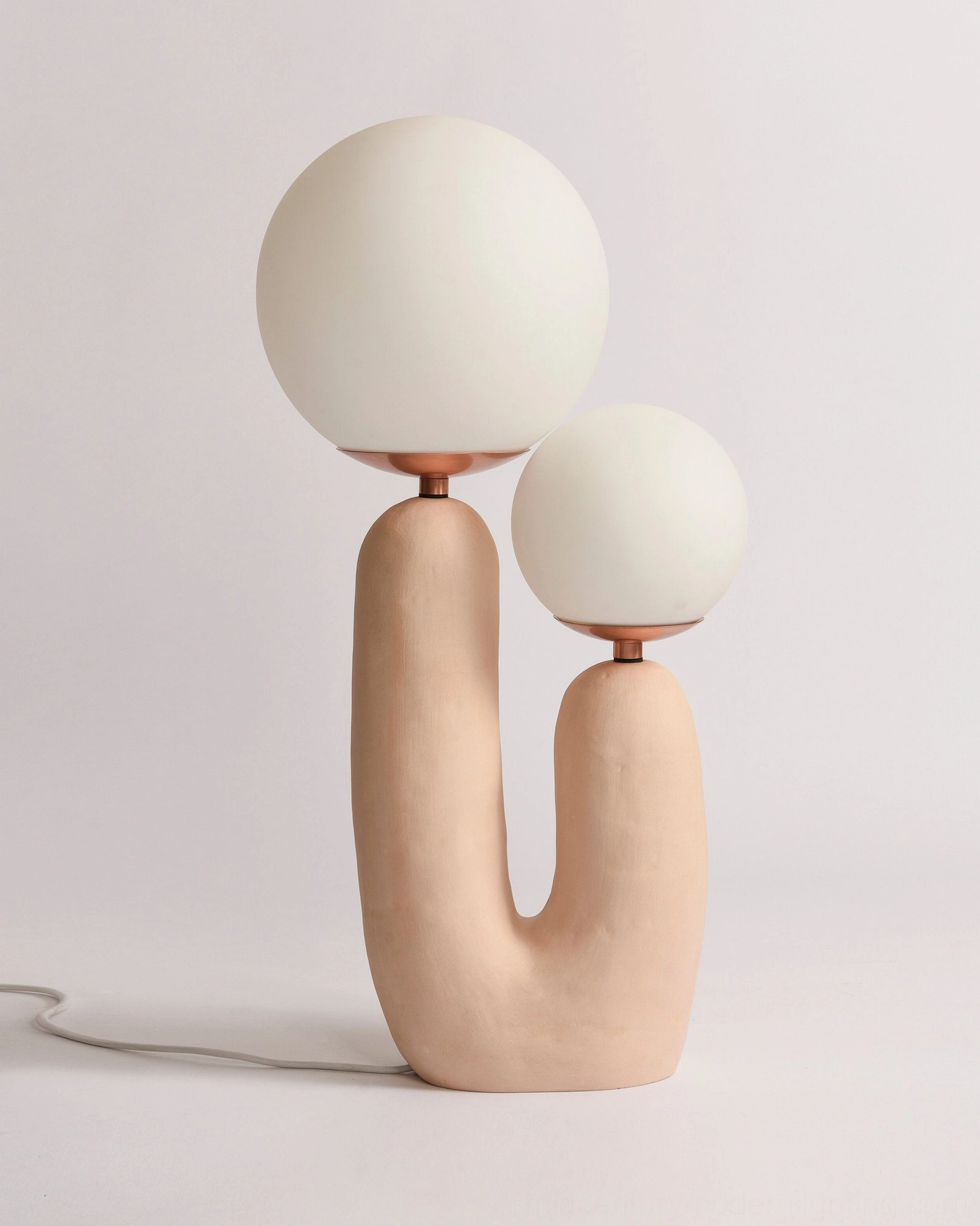 Oo textured table lamp with neutral ceramic base and visible power cord