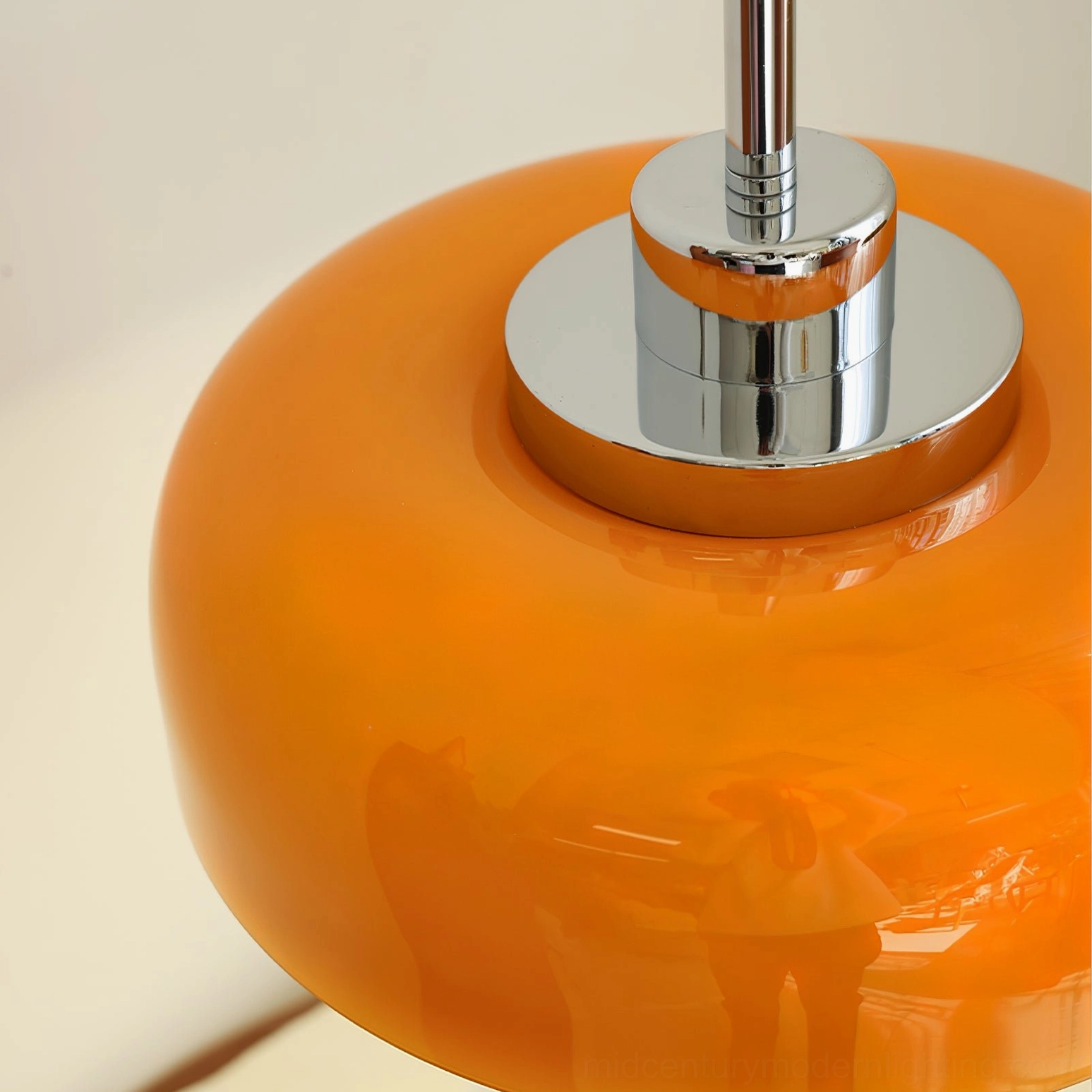 Mid-century modern orange table lamp showing chrome pedestal and cord with push button switch