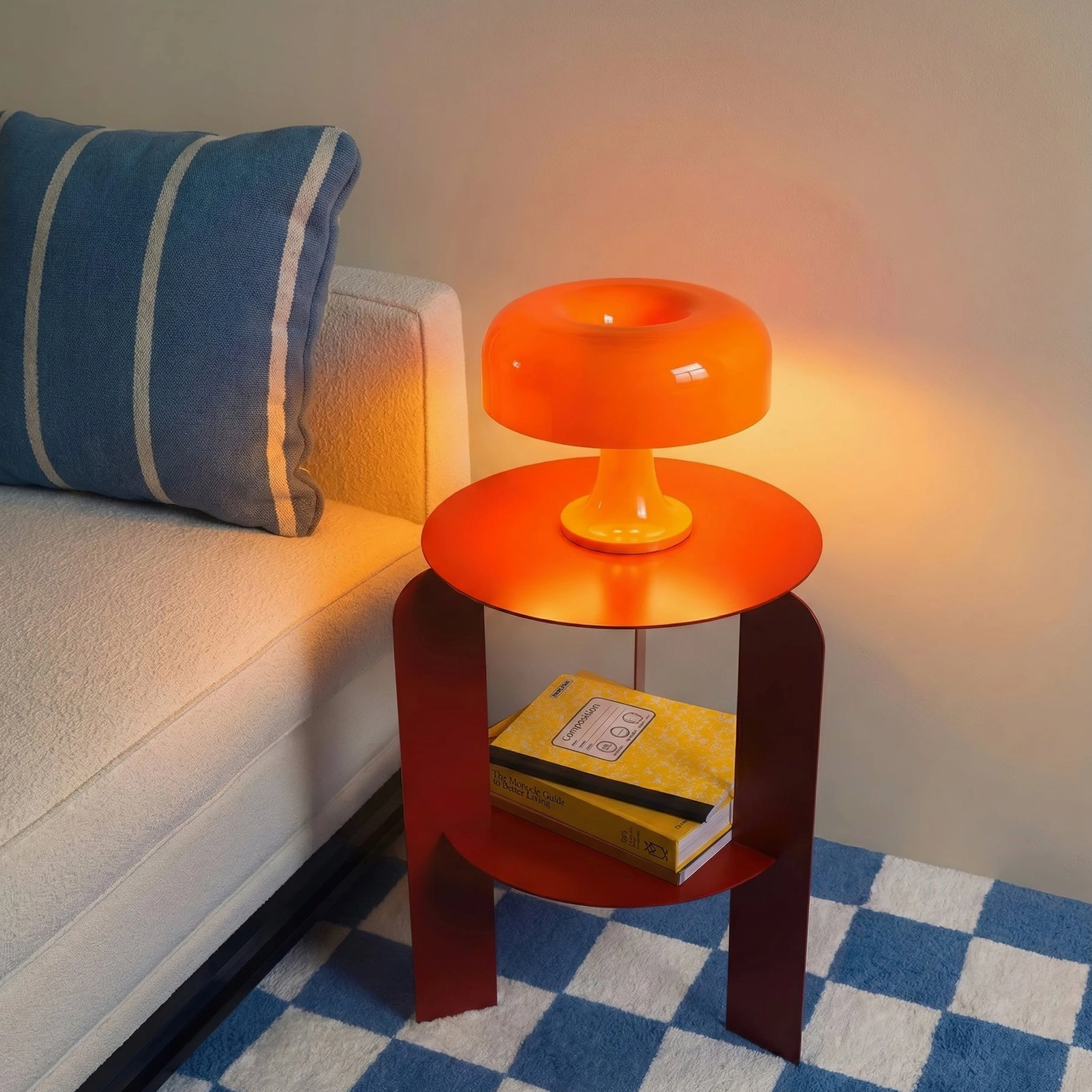 Orange mushroom table lamp three-quarter side view on dark red side table with checkered floor rug in living room