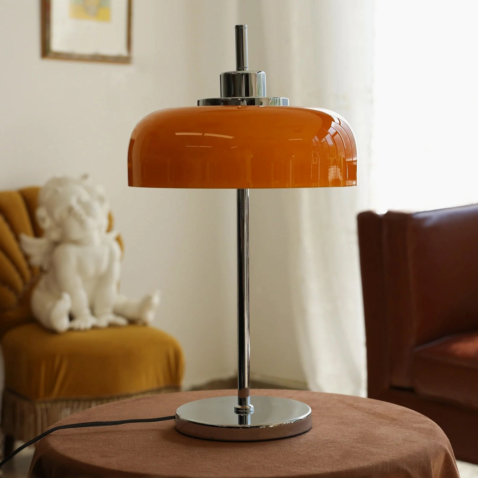 Retro burnt orange table lamp on brown round table with leather sofa in cozy vintage living room