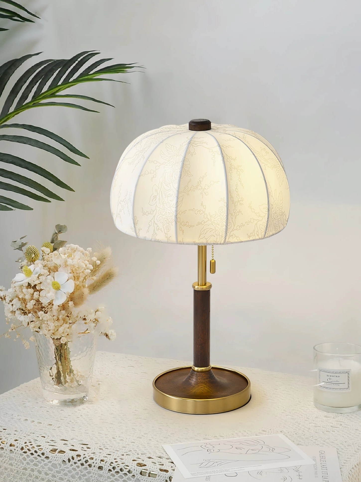 Orchid table lamp with warm minimalist style on lace tabletop with dried flower arrangements