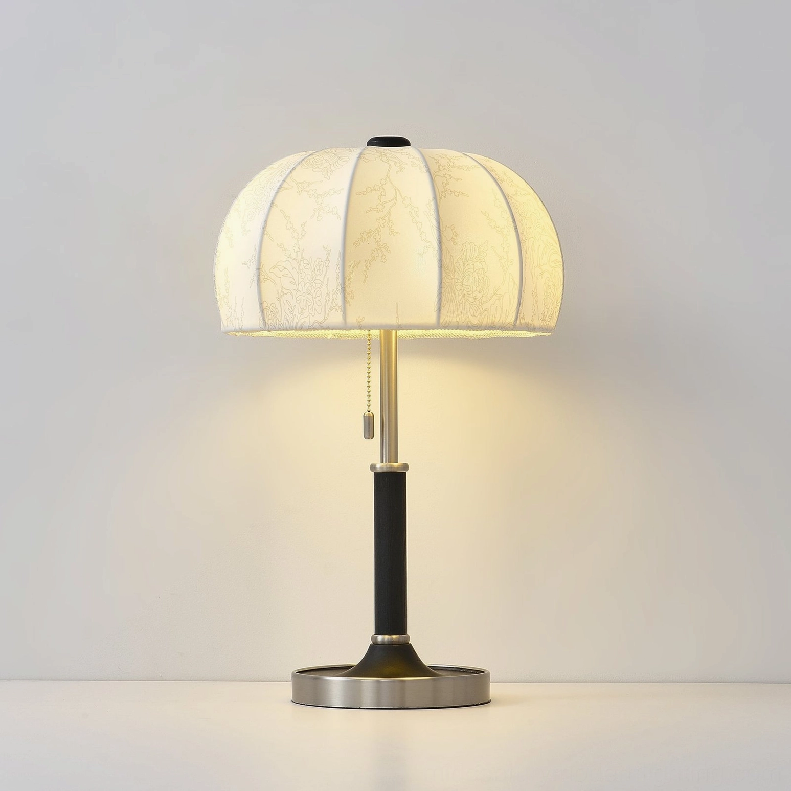 Orchid fabric table lamp in reading nook setting with armchair and books