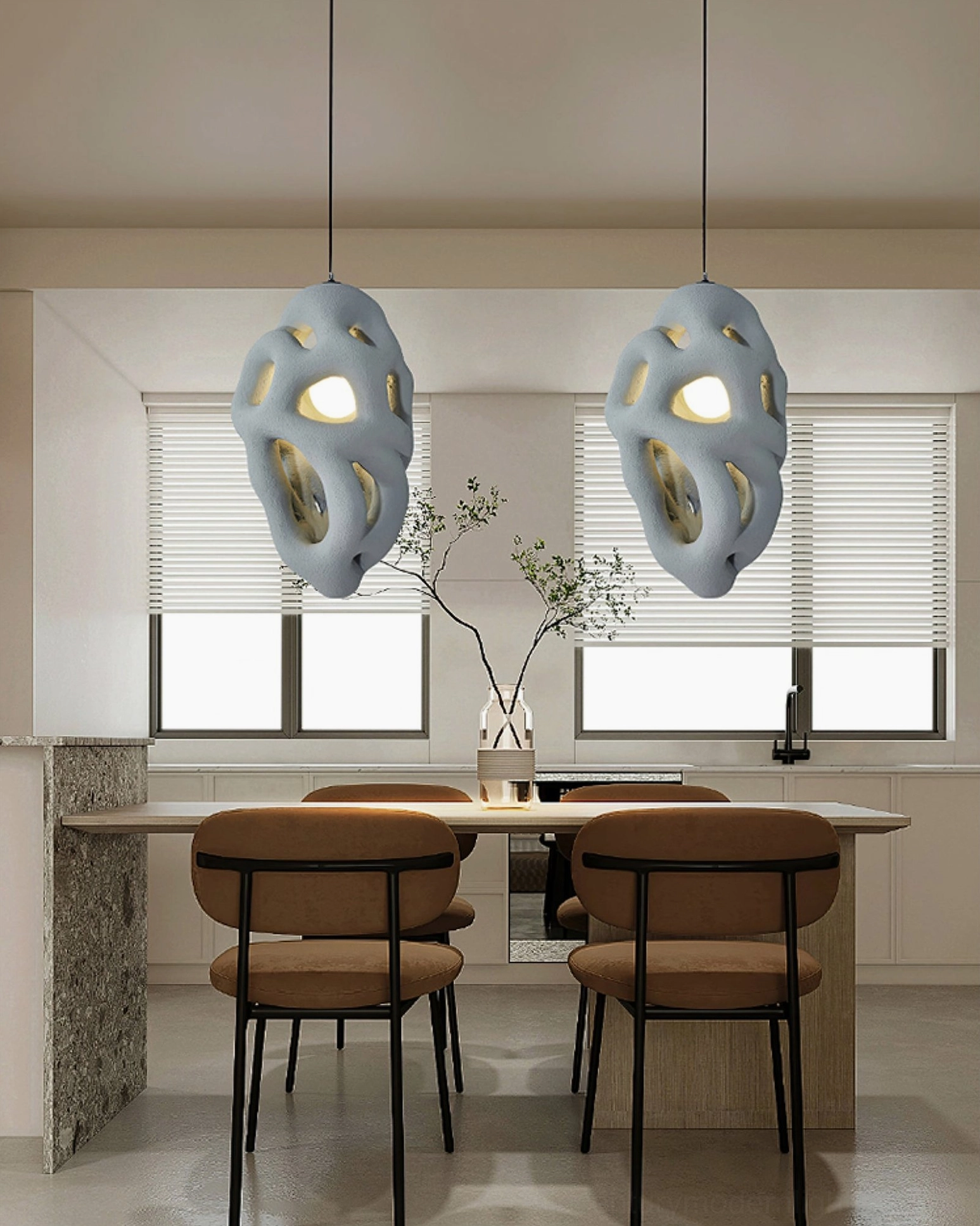 Two blue organic nest pendant lamps hanging in modern kitchen dining area, muted blue matte finish lighting