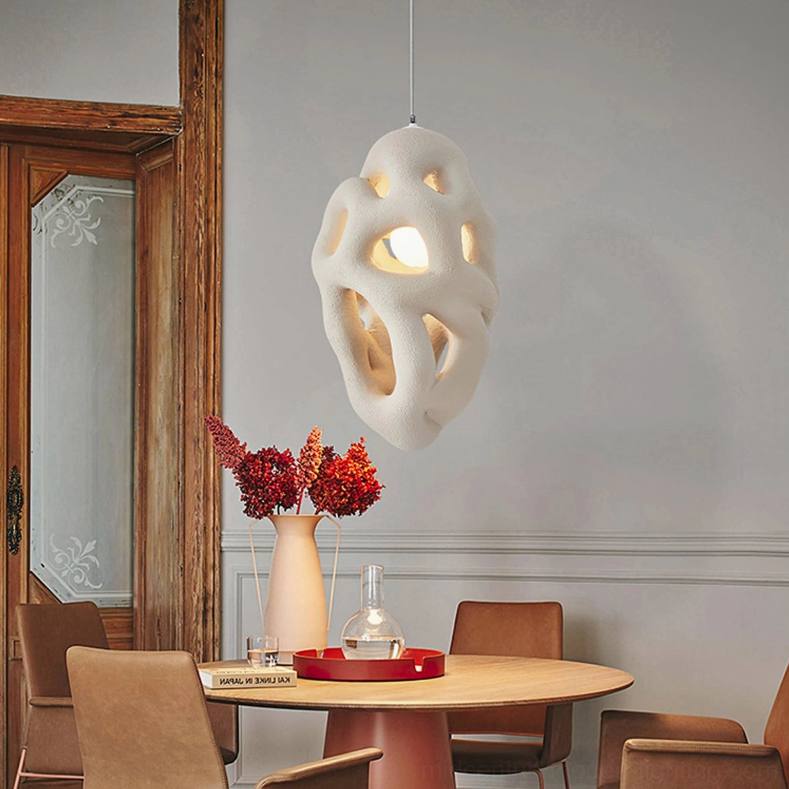 Organic nest pendant hanging in vintage dining room, creating ambient shadow play on wall, contemporary pendant light