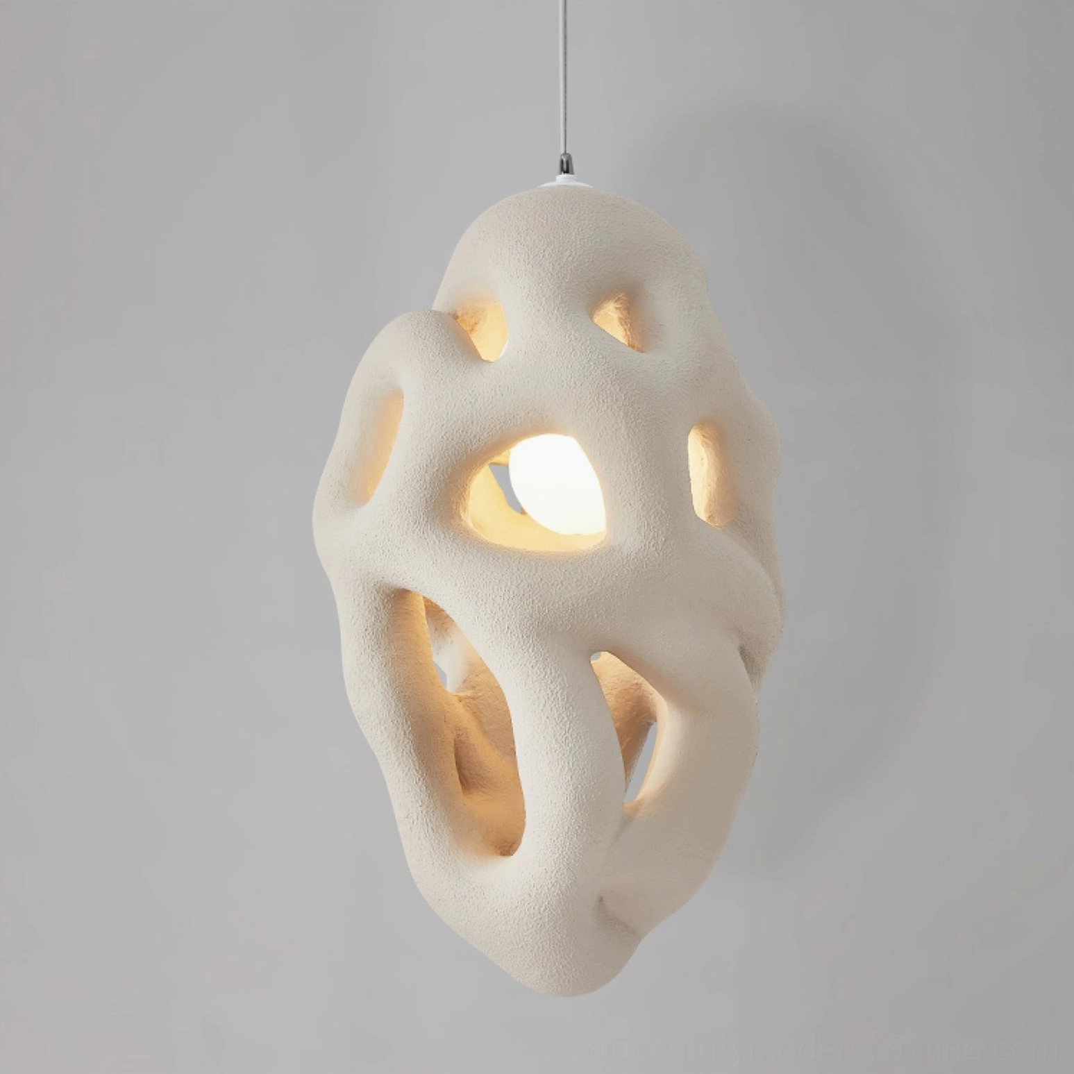 Close-up of organic nest pendant lamp showing porous honeycomb texture, irregular organic surface detail