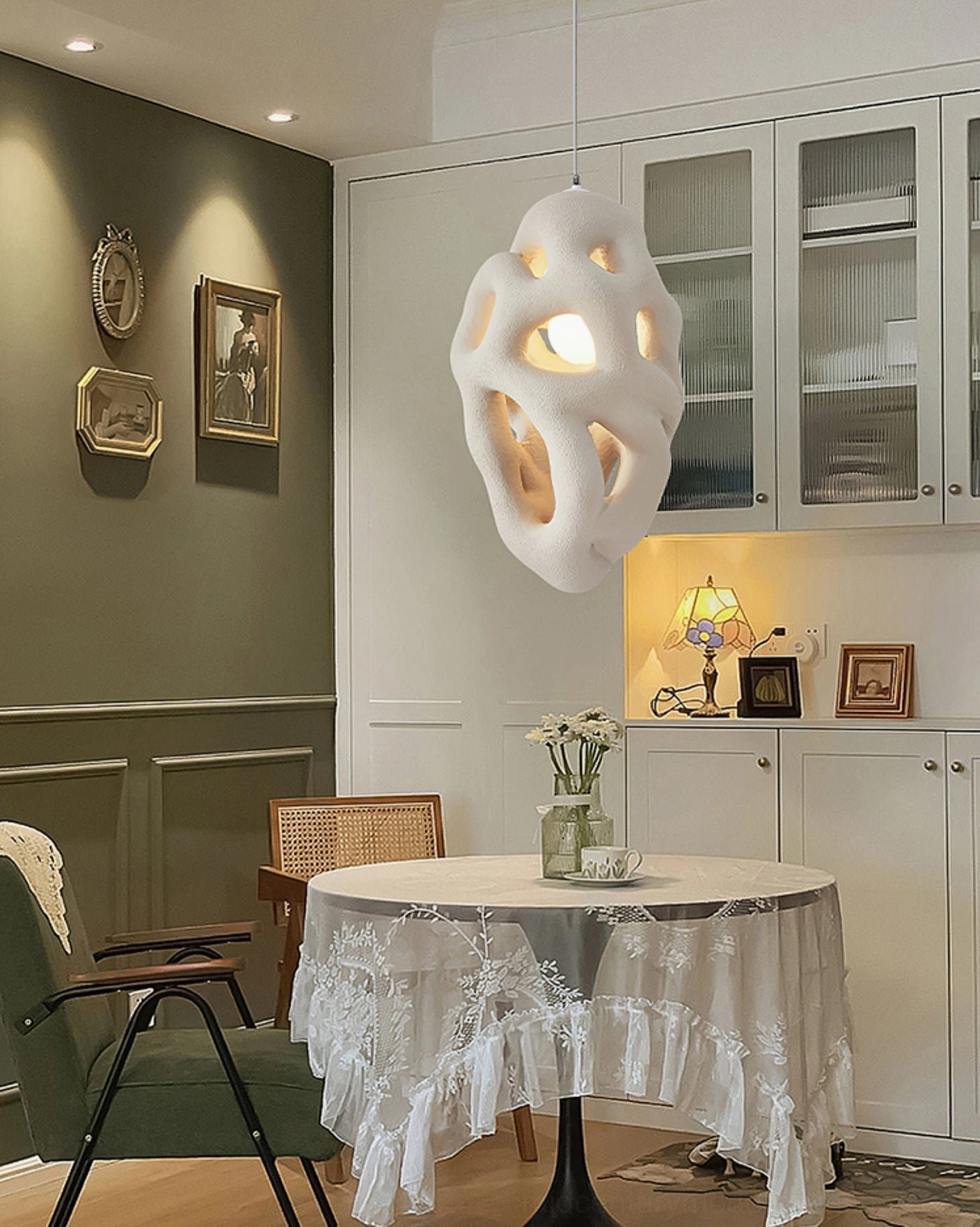 Organic nest pendant light in vintage green wall dining room, elegant warm home decor setting