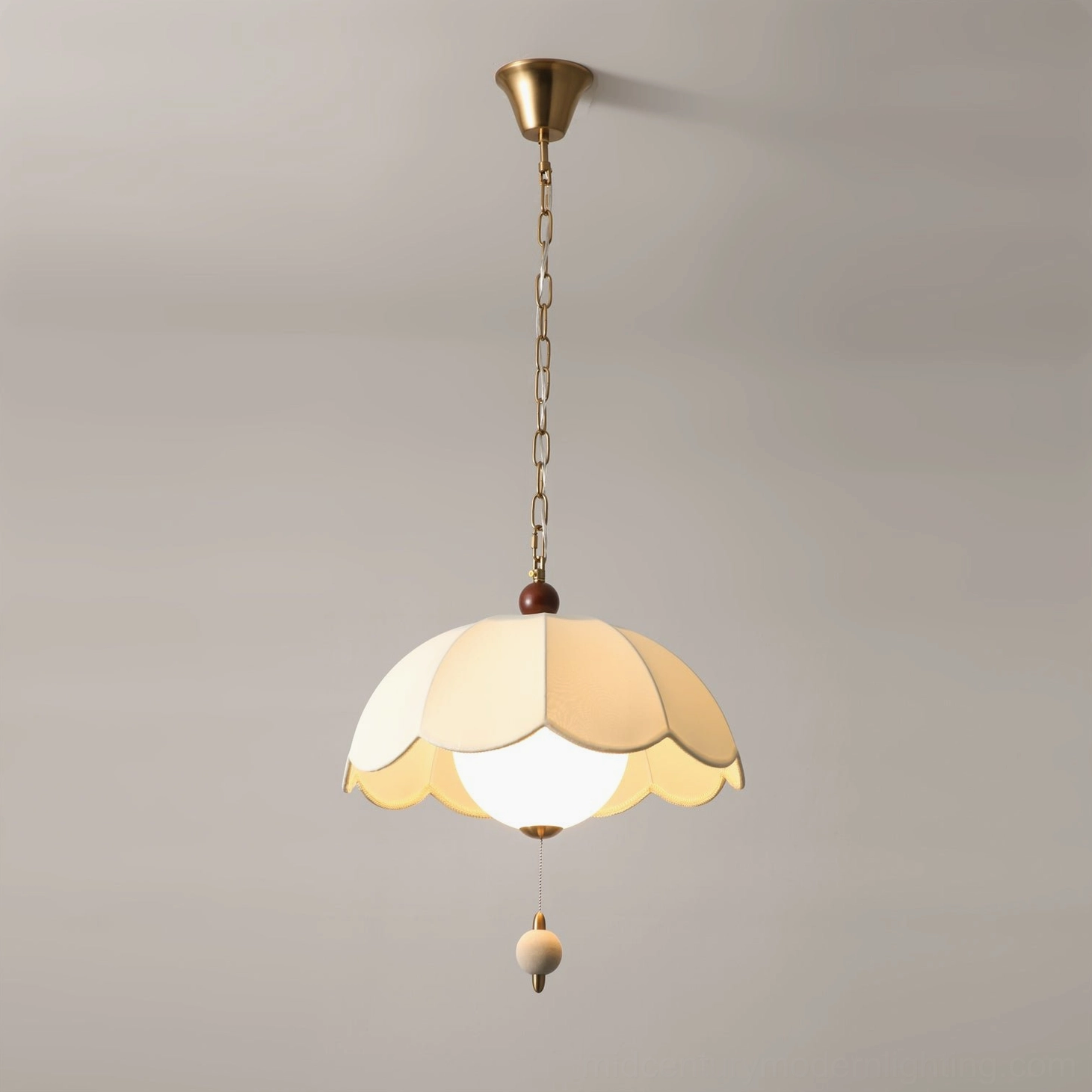 Oriente scalloped pendant with exposed Edison bulb and brass hardware, frontal hanging view