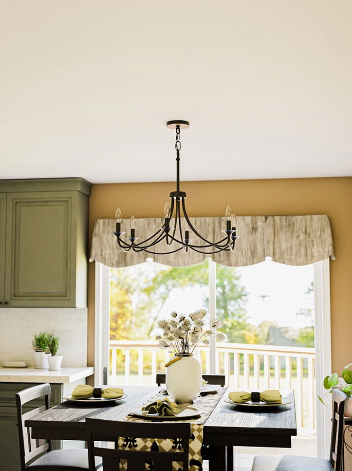 Black farmhouse chandelier in combined kitchen-dining room creating focal point in casual traditional home