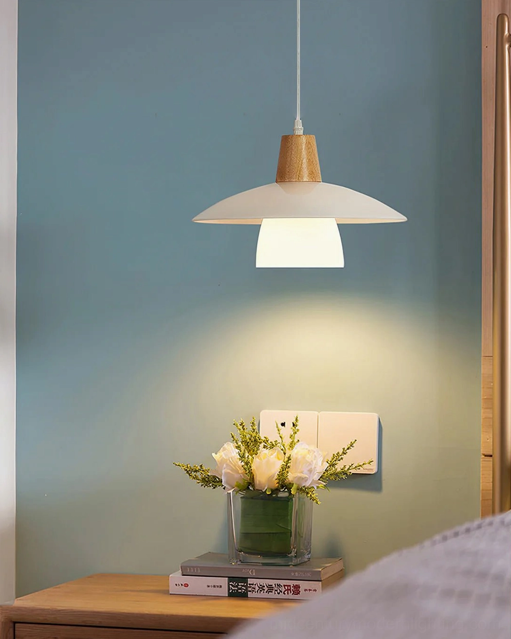 Overhead view of minimalist pendant light displaying matte white frosted glass and natural wood materials