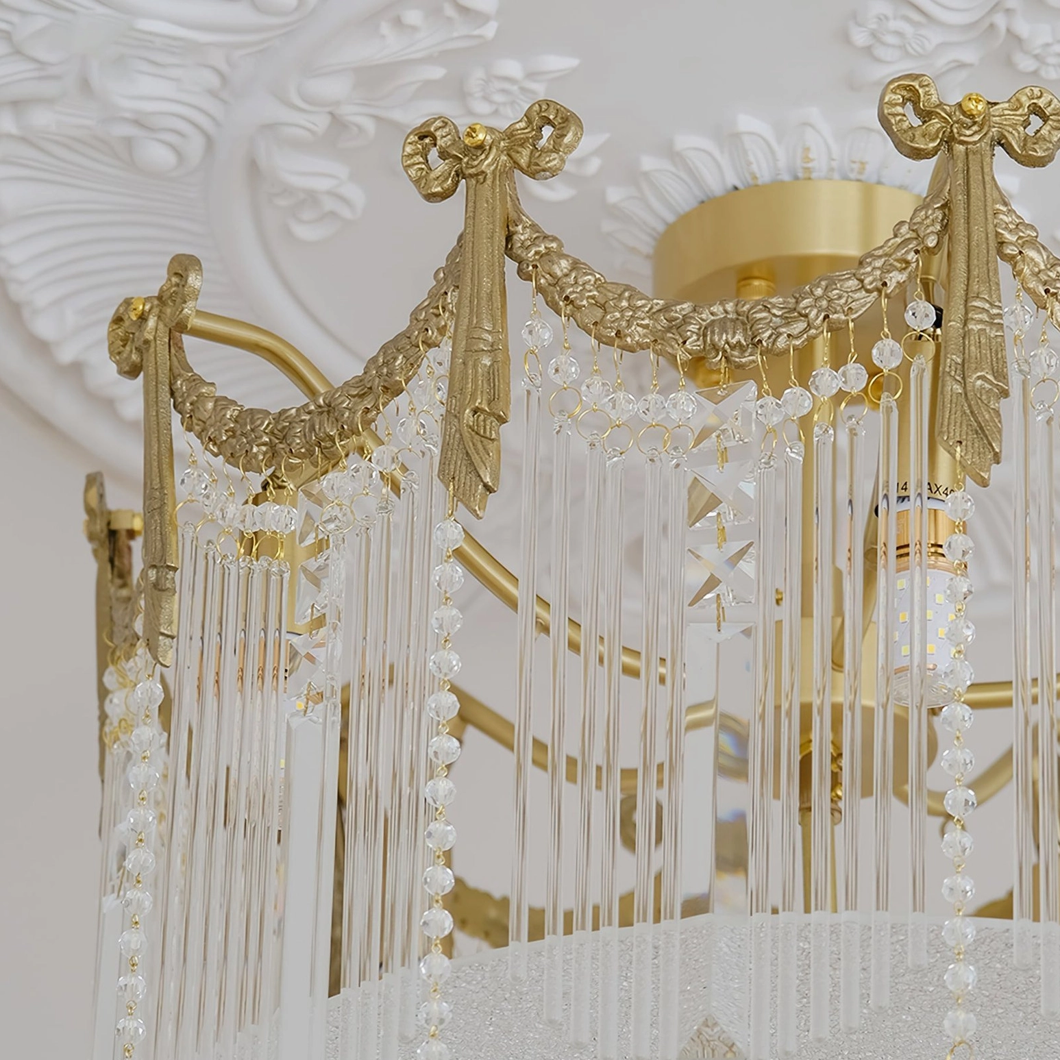 Crystal water drop ceiling lamp showing crystal bead arrangement and brass framework design