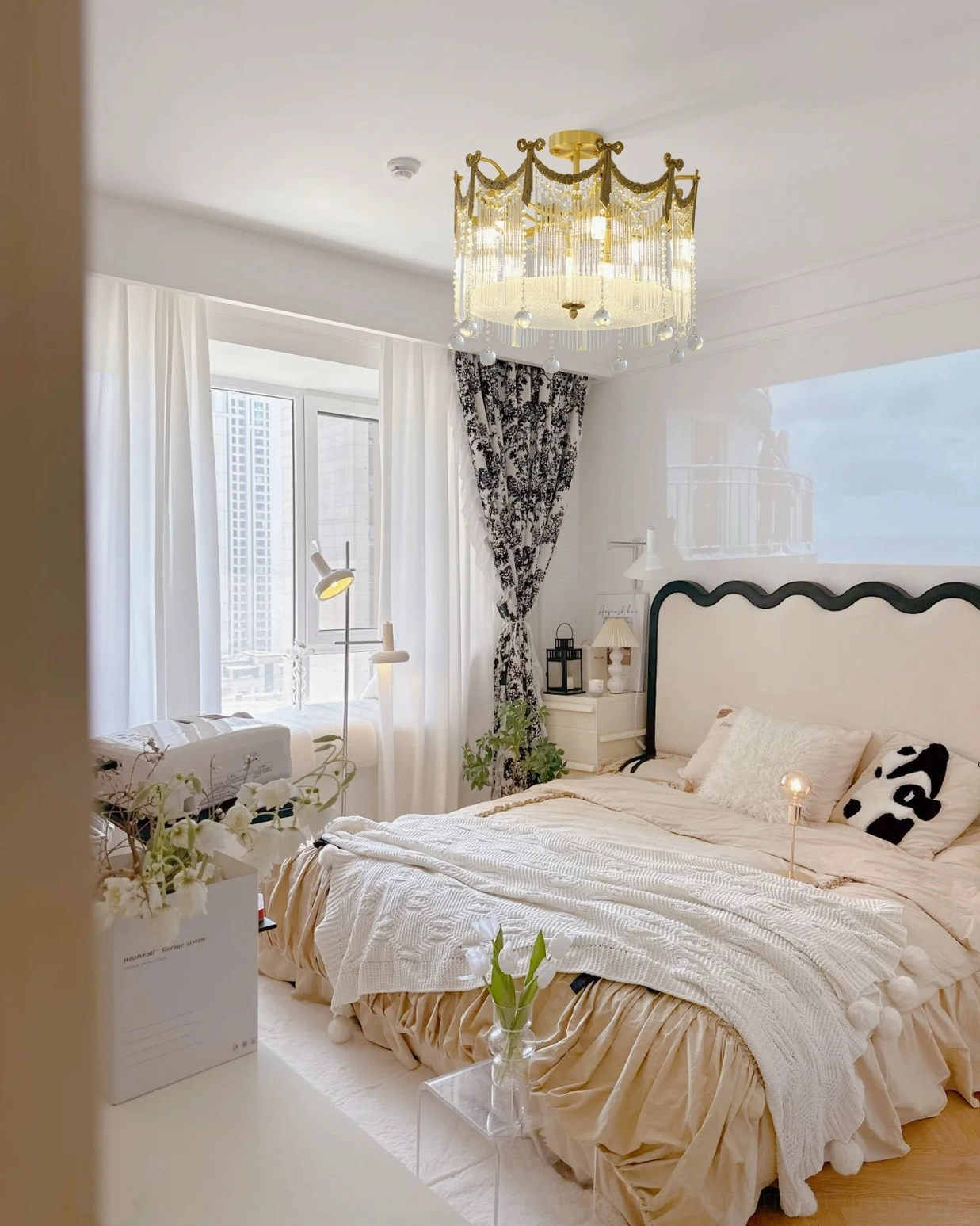 Water drop ceiling lamp in eclectic style bedroom with black white pillows and mixed home decor