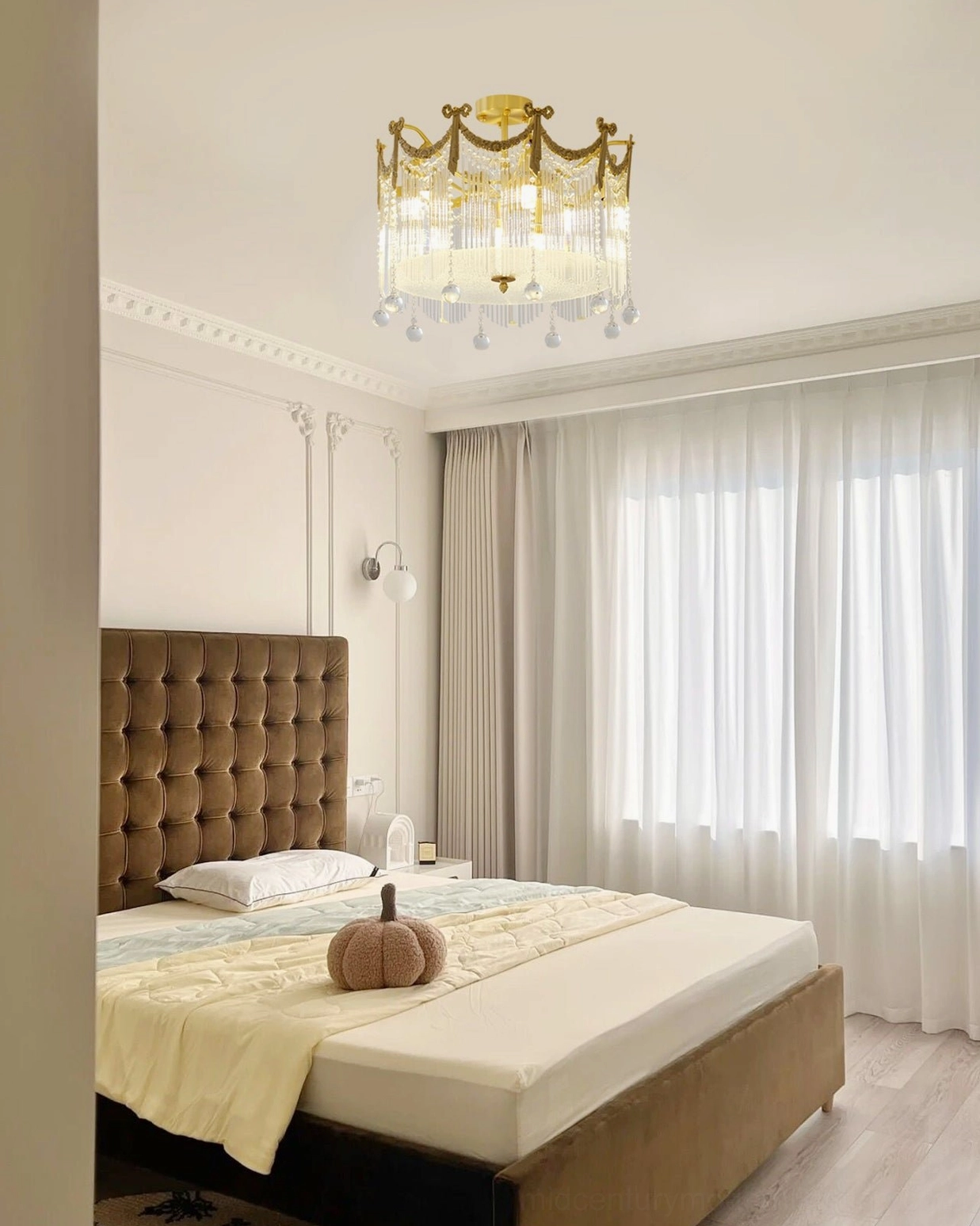 Brass crystal water drop ceiling lamp in luxury brown bedroom with tufted headboard