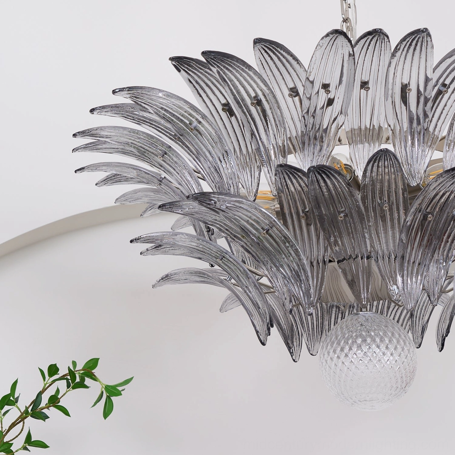 Palazzo Ball Chandelier demonstrating sculptural glass leaf form and metal hardware in contemporary styled room