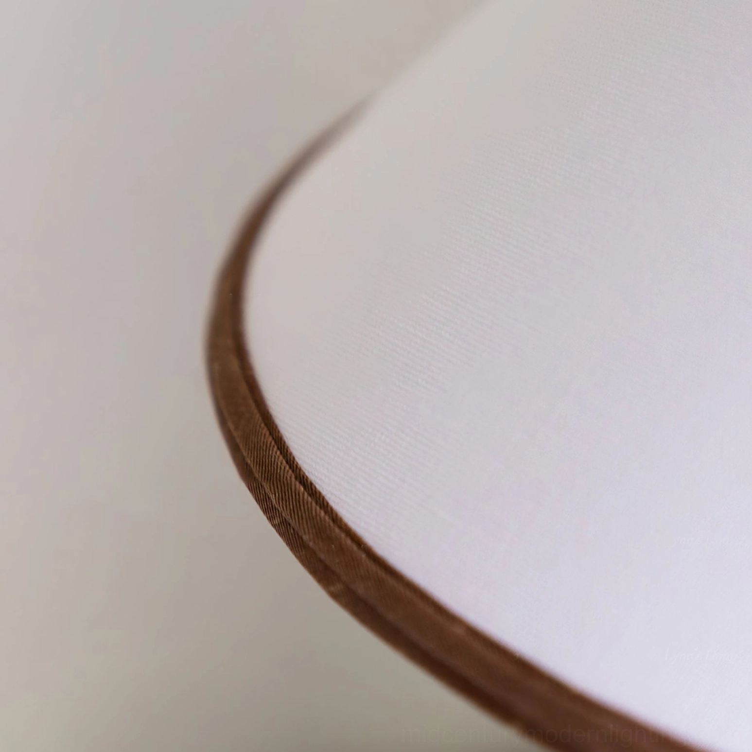 Palisades conical lamp shade edge detail showing brown fabric trim on white woven material