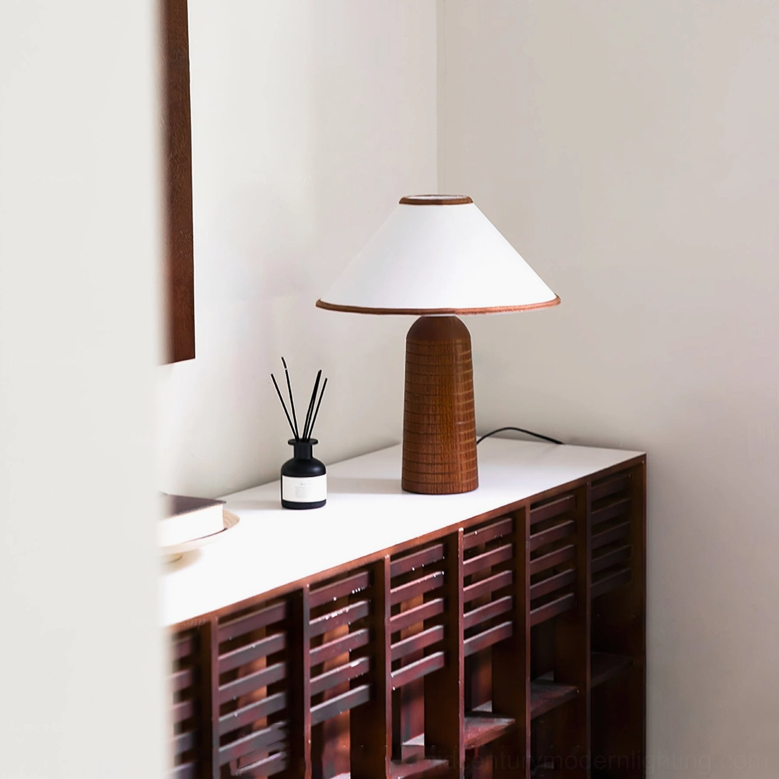 Palisades mid-century modern lamp on wooden console table right-side angled view with reed diffuser