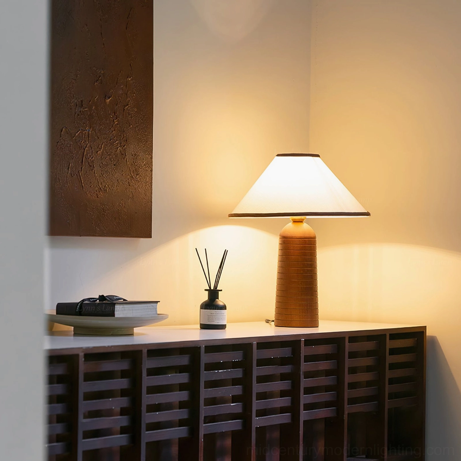 Lit Palisades wooden table lamp on slatted wood console creating warm ambient glow