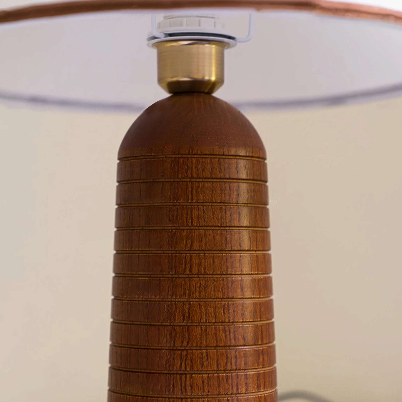Palisades lamp base close-up showing brown ribbed turned wood with brass metal fixture connection