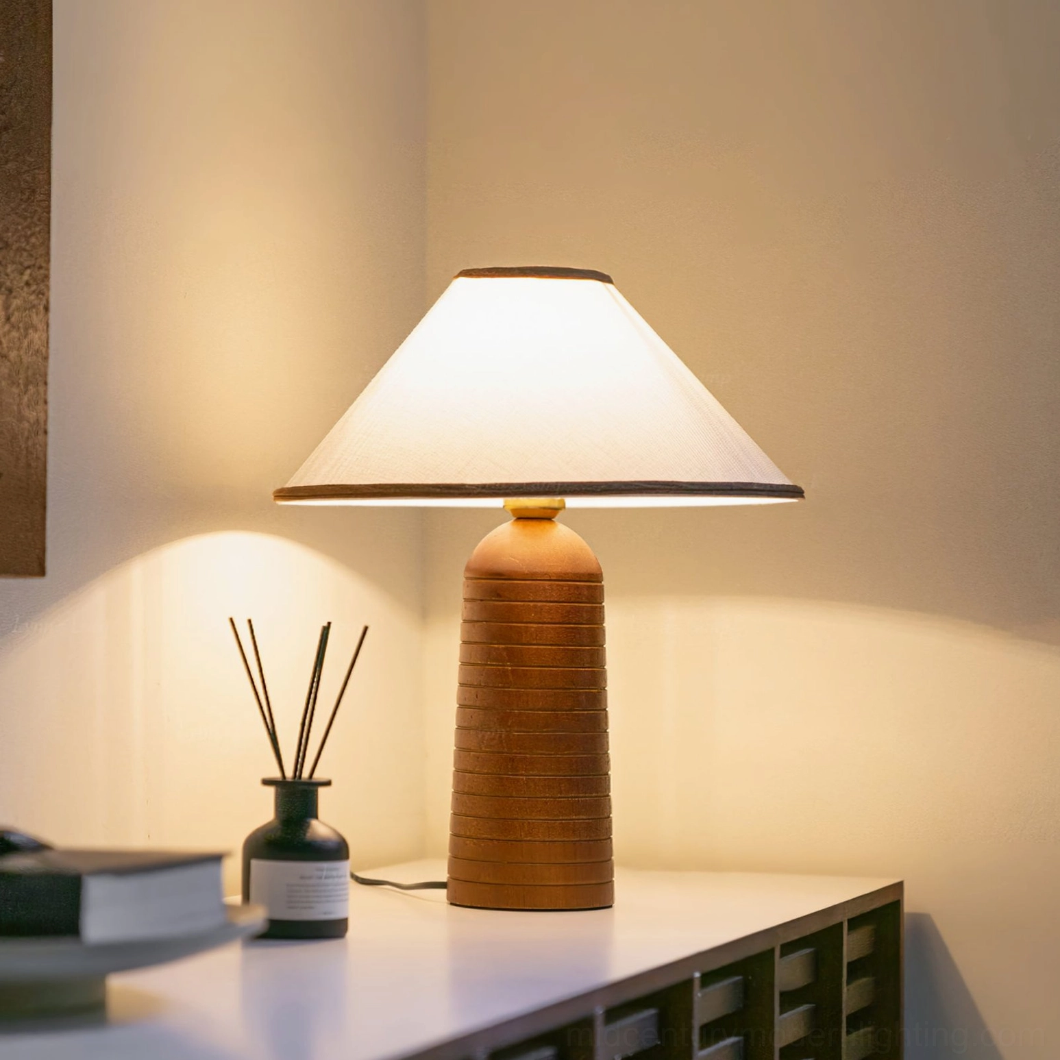 Evening ambiance with illuminated Palisades lamp on console table beside books and decor