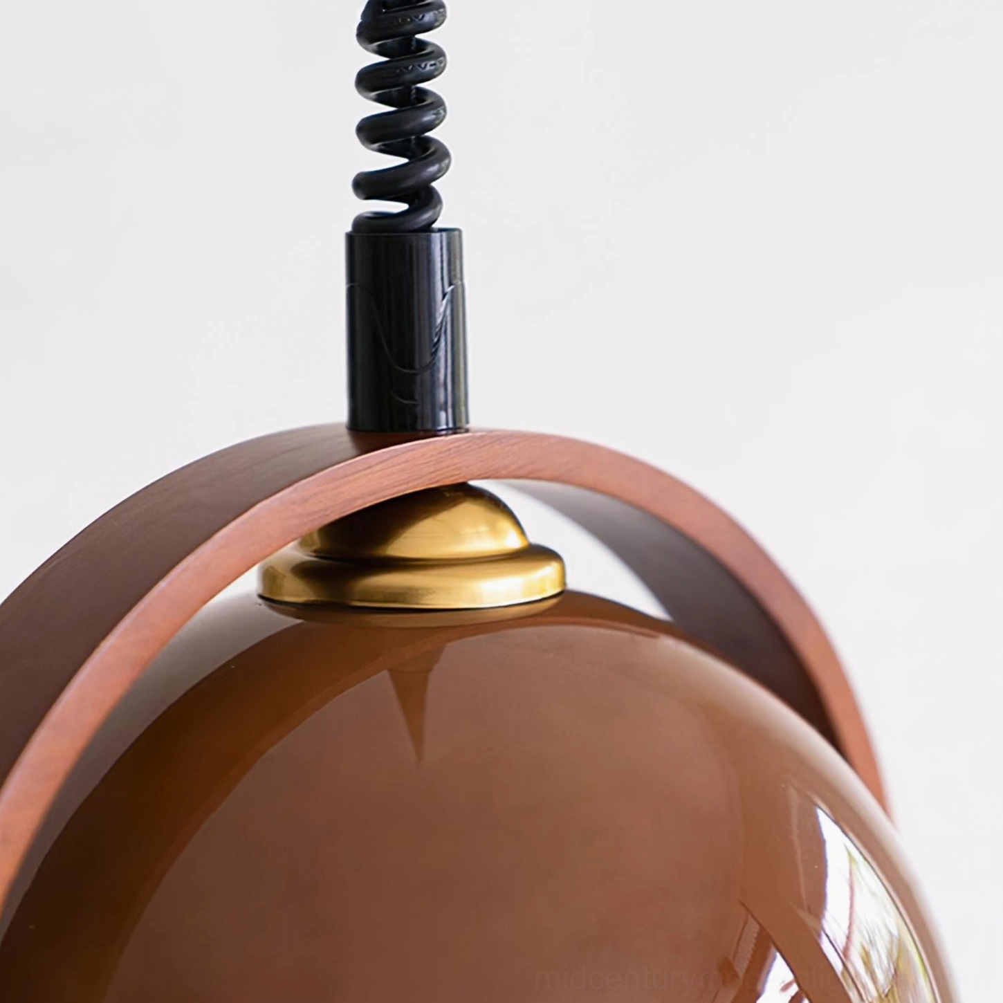 Pallade pendant lamp top mounting hardware with black spiral cord and brass ceiling canopy detail