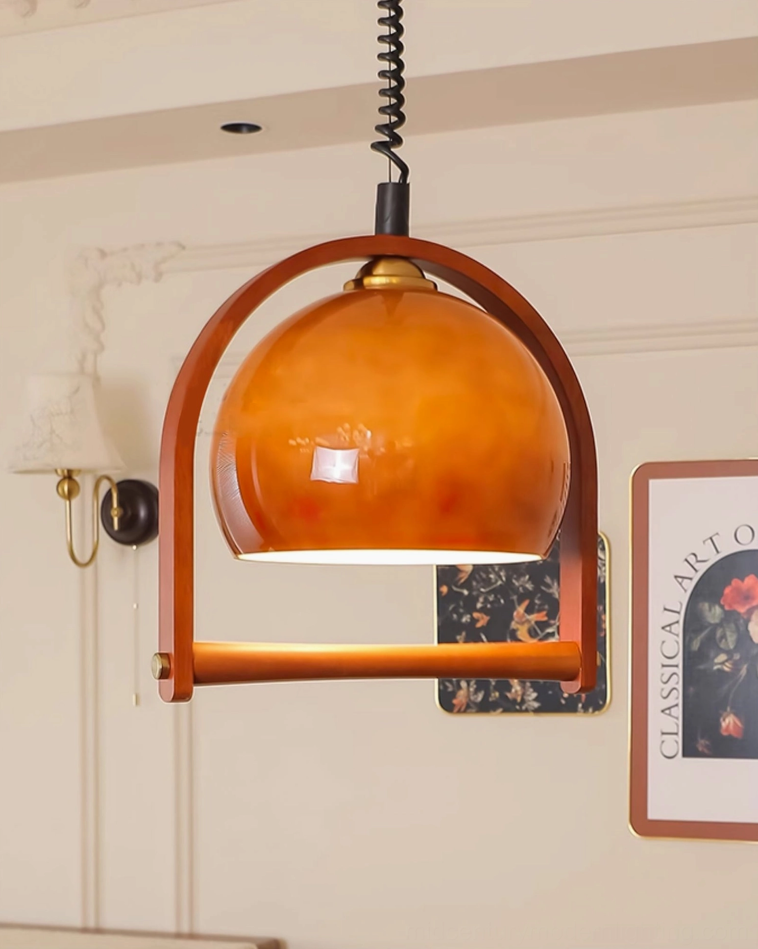 Pallade walnut pendant lamp three-quarter view in hallway with wall art and warm ambient lighting