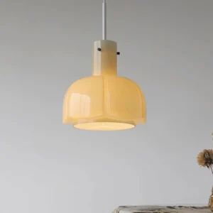 Warm beige Paolina pendant lamp in vintage minimalist home setting with grey walls and dried flowers