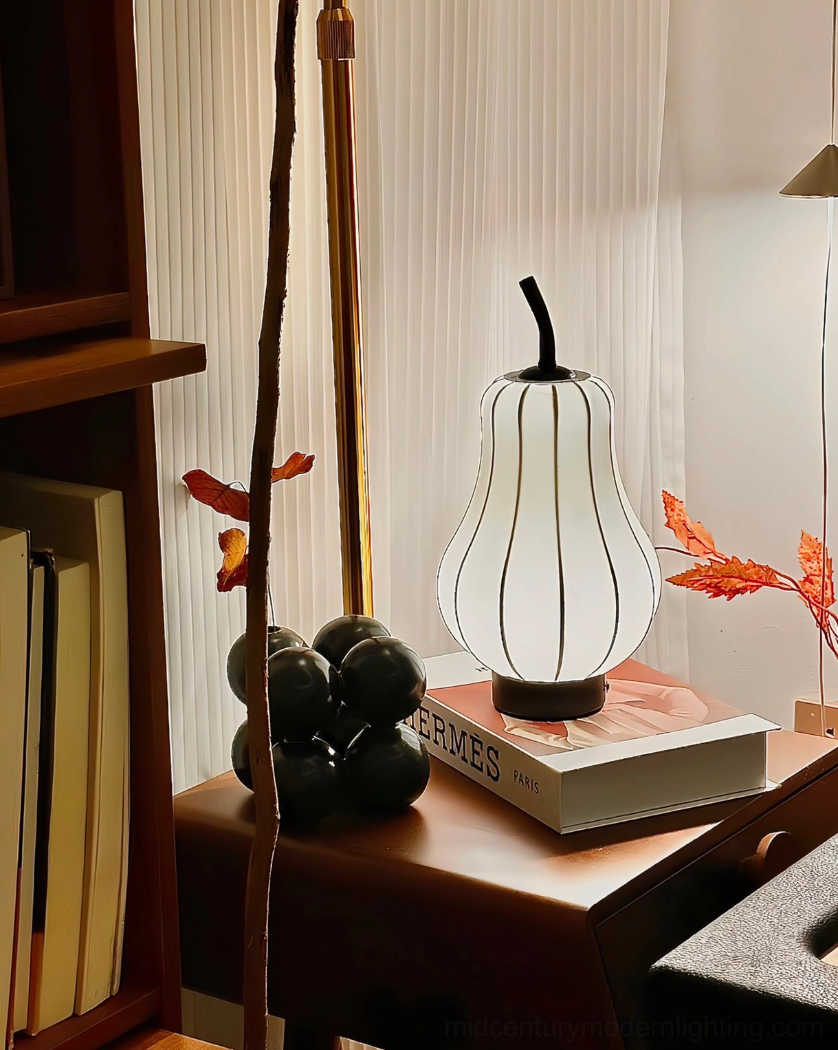 Pear cordless lamp with warm light glow displayed with art decor and bird print wall