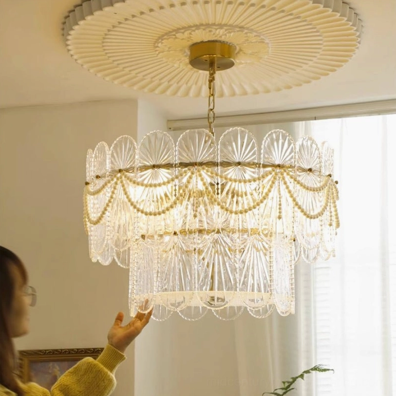 Art Deco chandelier with pearl beaded trim and gold frame displayed in bright modern living room