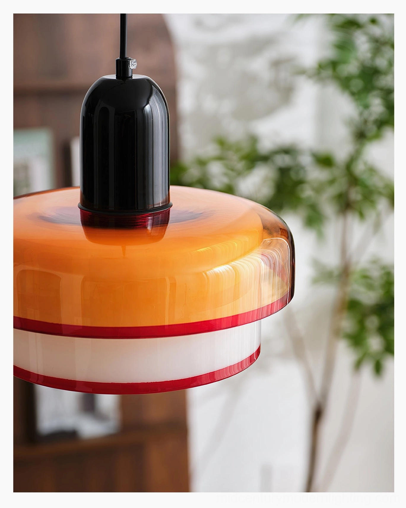 Close-up detail of amber glass shade with red accent trim and black metal mounting hardware