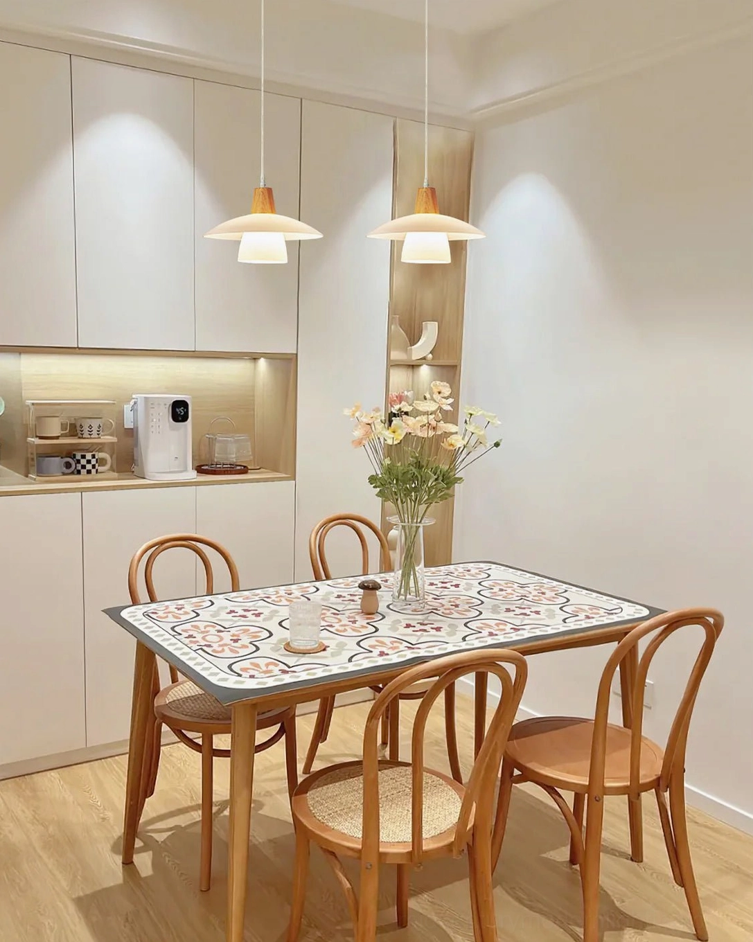 Minimalist pendant light with suspension wire displayed against neutral background showing full profile