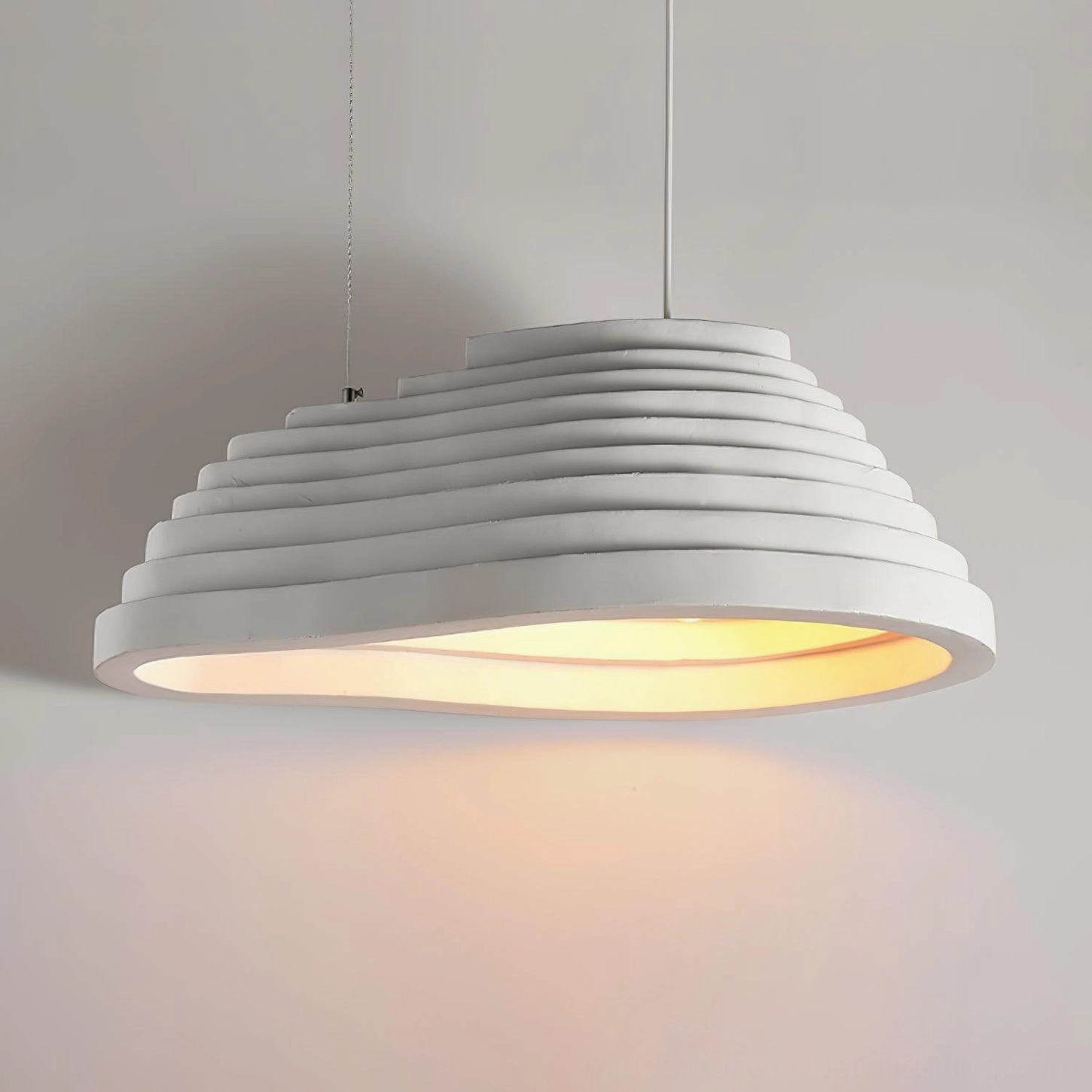 Close-up detail of wavy tiered texture and matte white finish on organic pendant lamp