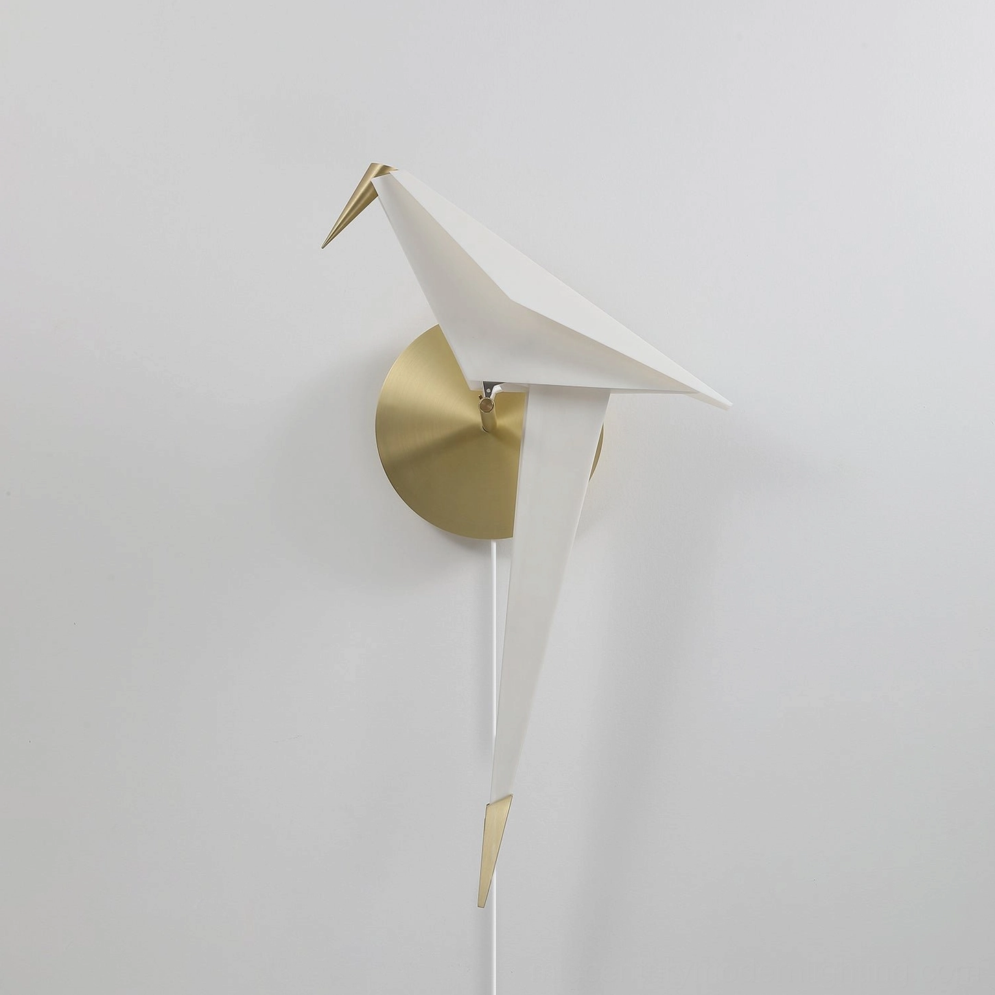 Unlit Perching Bird wall lamp white matte finish against pure white wall frontal view natural daylight