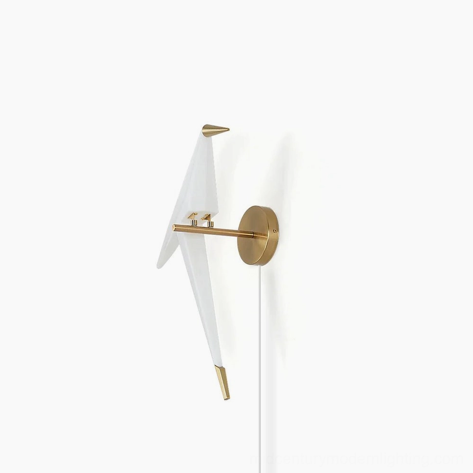 Perching Bird wall lamp with white acrylic body and gold metal hardware on plain background, frontal view