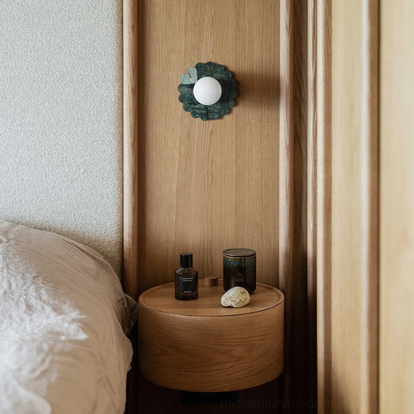 Petal marble wall sconce installed in minimalist bedroom as bedside ambient lighting fixture
