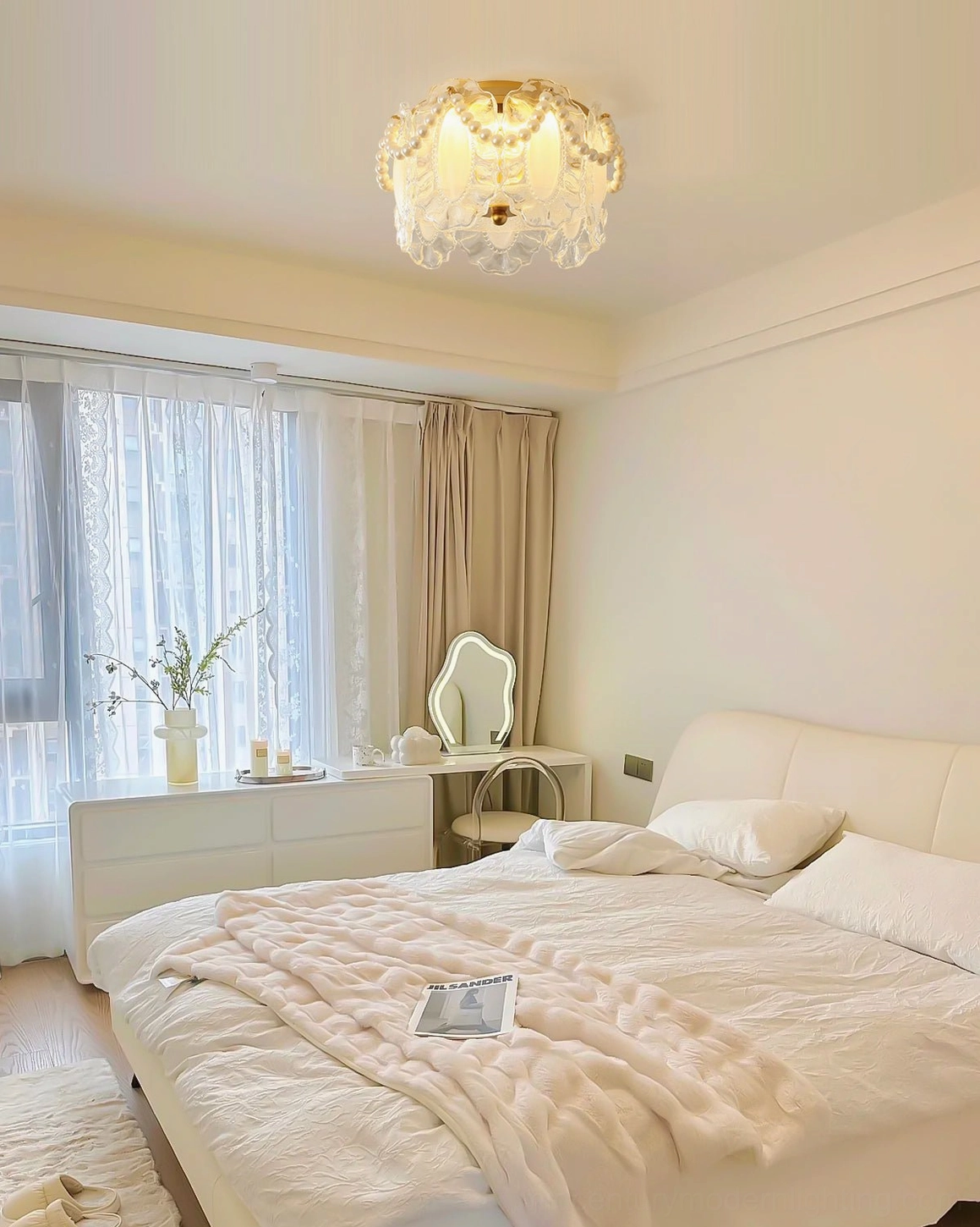 Petal Pearl ceiling light mounted in creamy French style bedroom creating ambient glow
