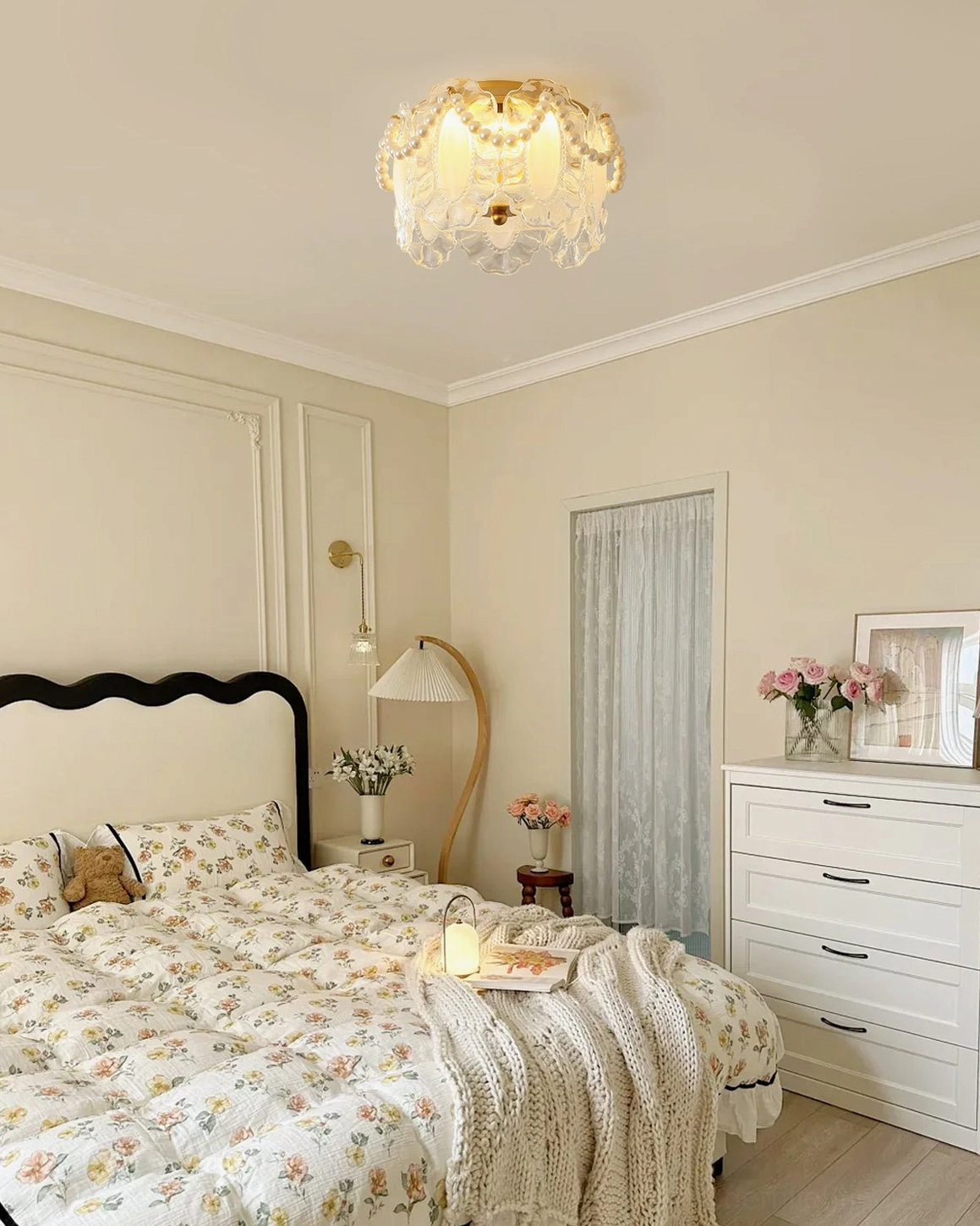 Petal Pearl fixture illuminated in light luxury bedroom with floral bedding