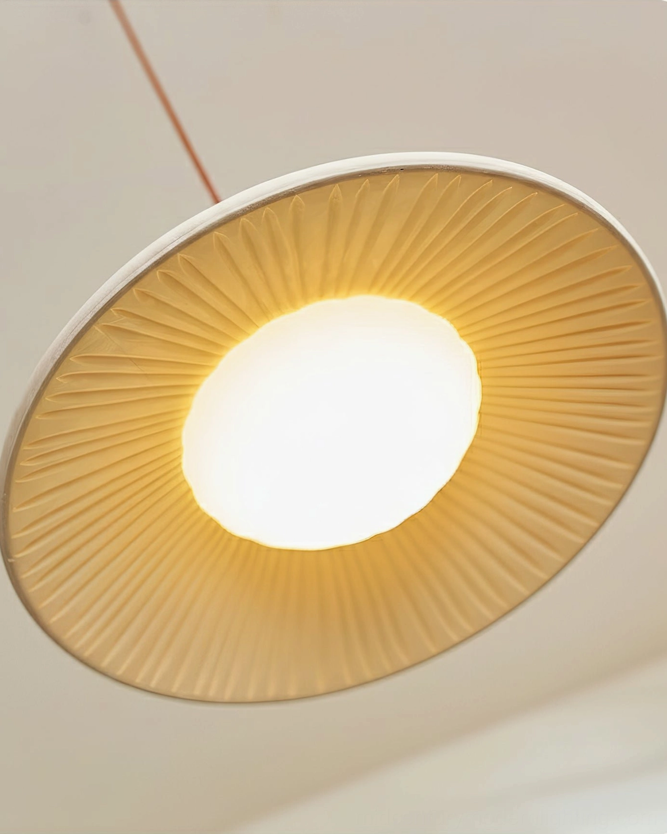 Piero pendant lamp overhead view radial ribbed texture warm central illumination