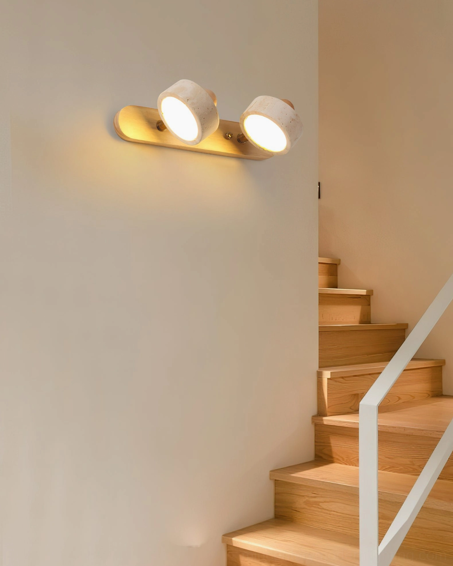 Piero 2-head travertine sconce side view residential staircase hallway, warm minimalist lighting