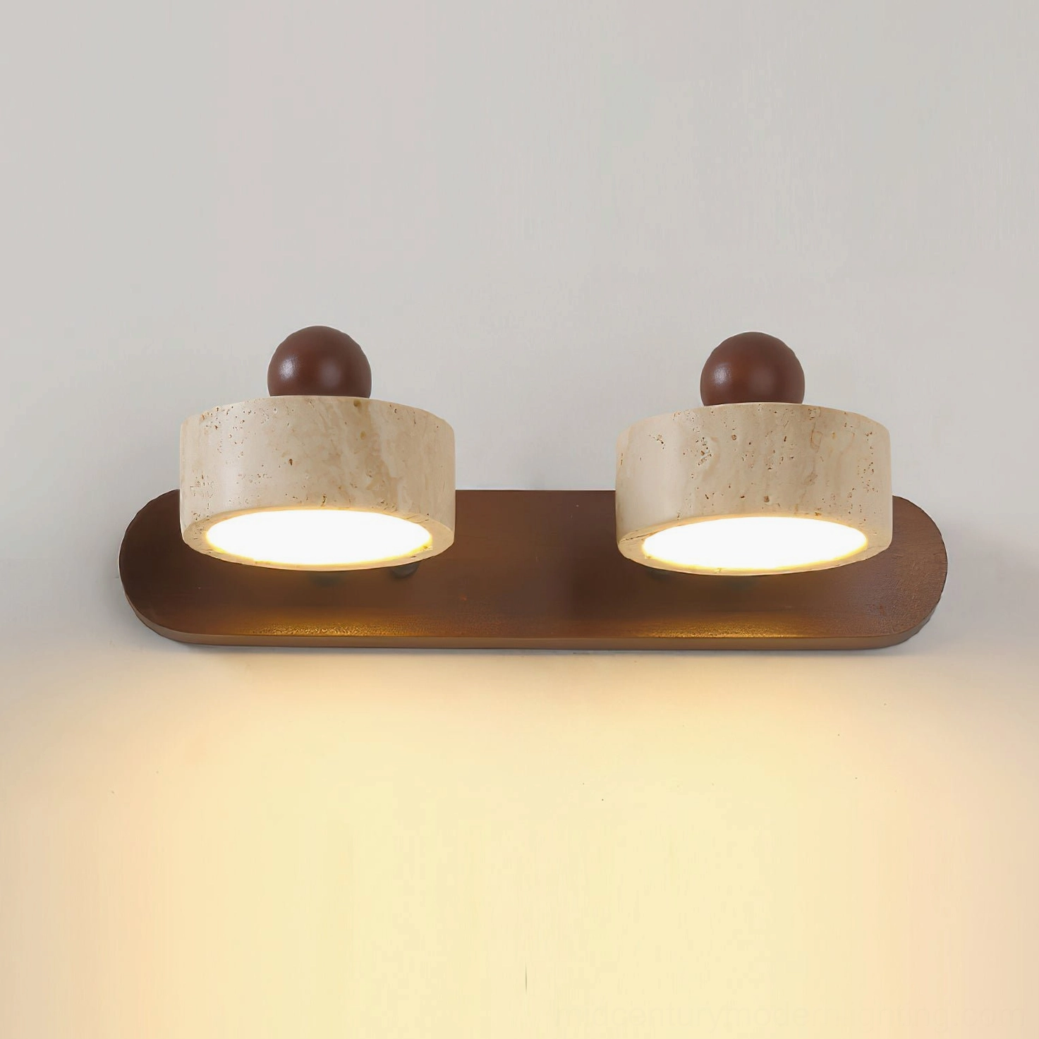 Piero 2-head travertine sconce close-up showing natural stone texture, dark wood base detail
