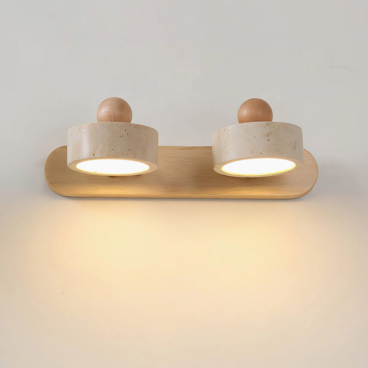Piero 2-head travertine wall lamp close-up, light natural wood frame, warm LED glow