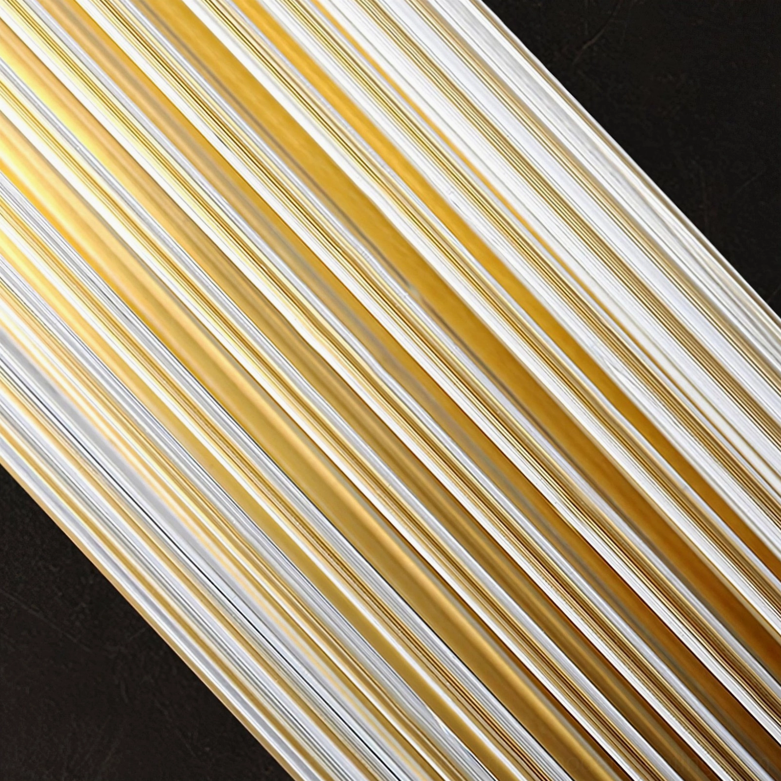 Close-up detail of ribbed striped glass shade with gold metal trim, showcasing premium material craftsmanship