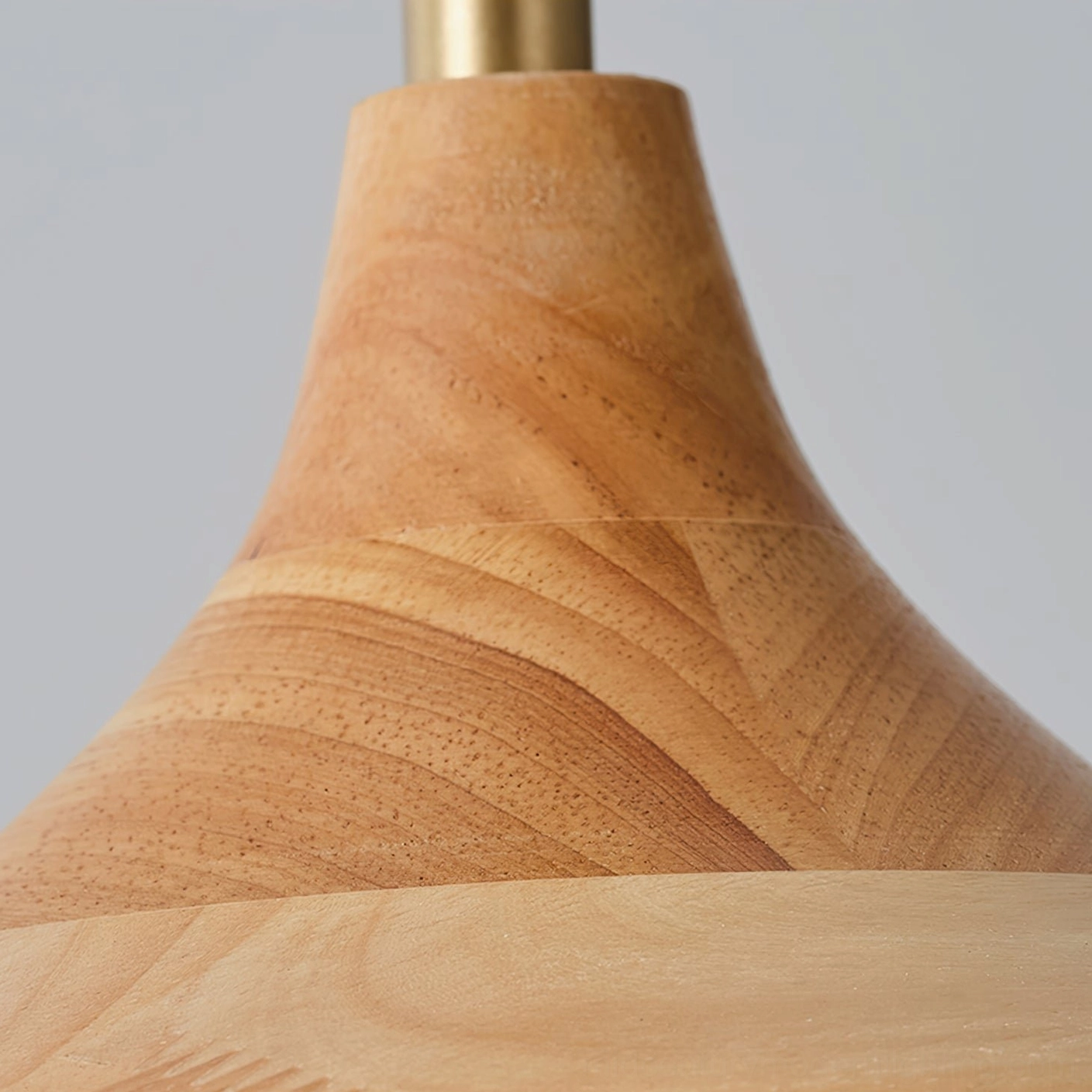 Macro close-up of Pimms ceiling mount showing solid natural wood construction with visible grain and brass metal hardware accent