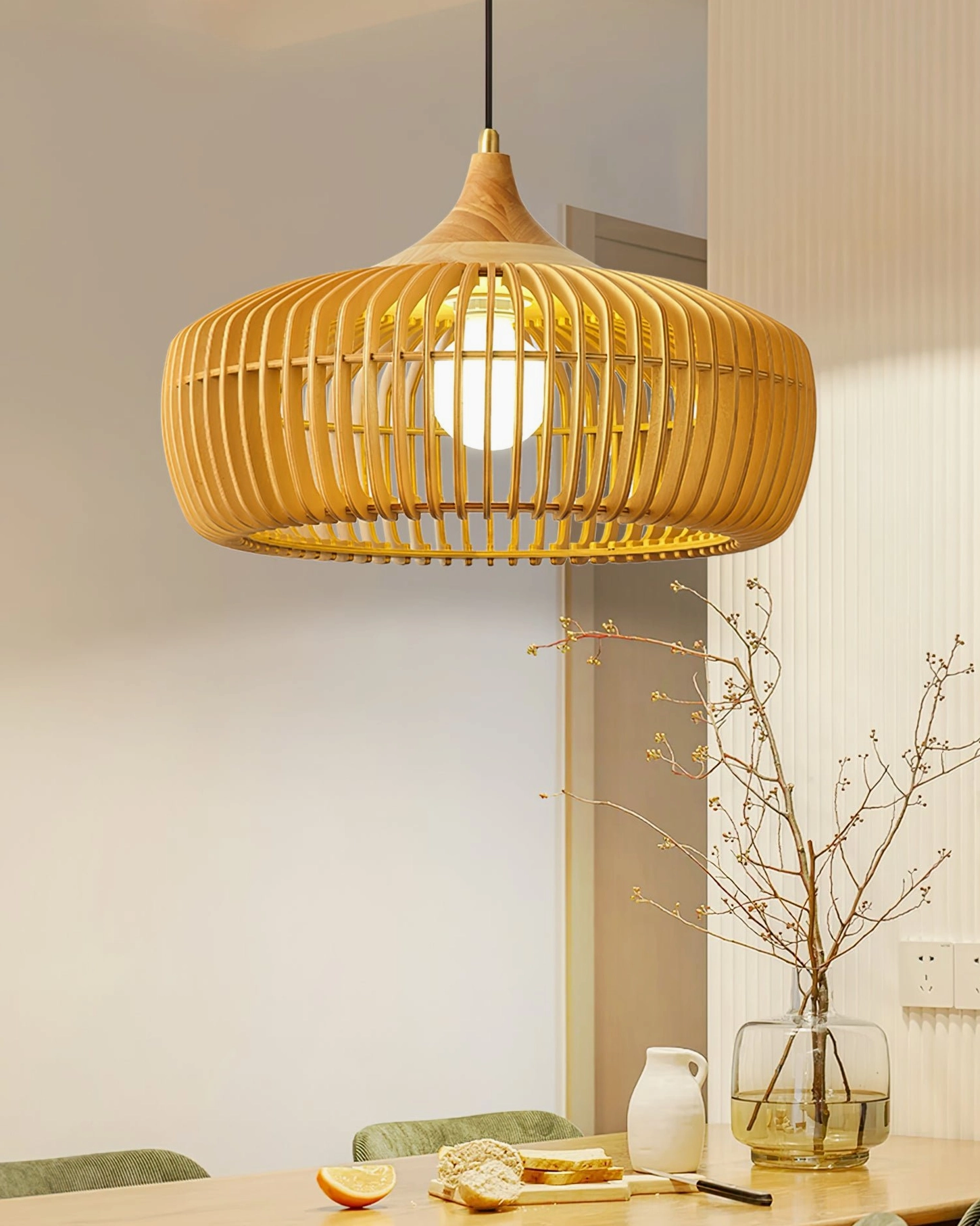 Light brown slatted Pimms pendant light installed above casual dining area with warm interior bulb creating soft ambient glow
