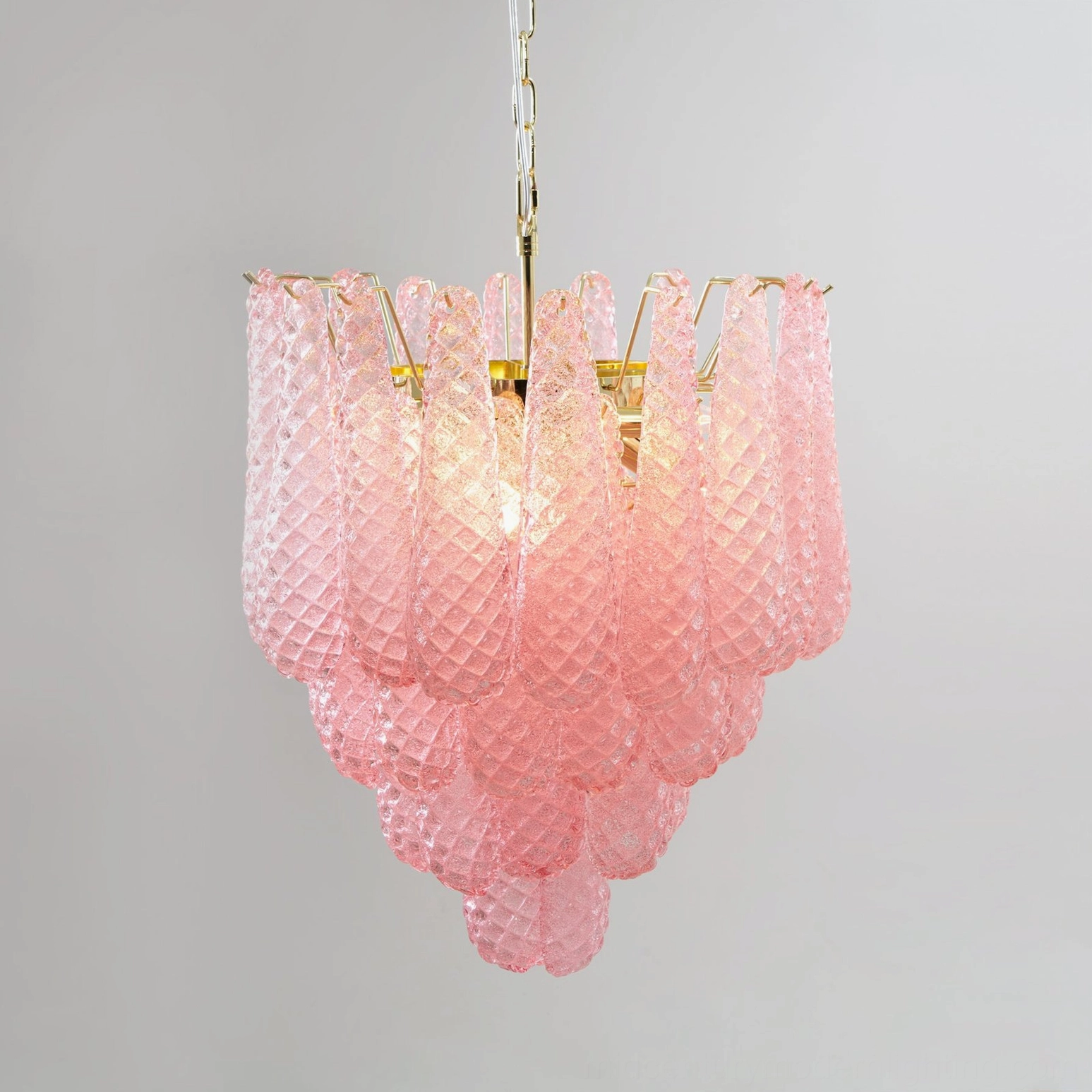Hand-blown pink glass chandelier detail view of gold metalwork frame and suspension
