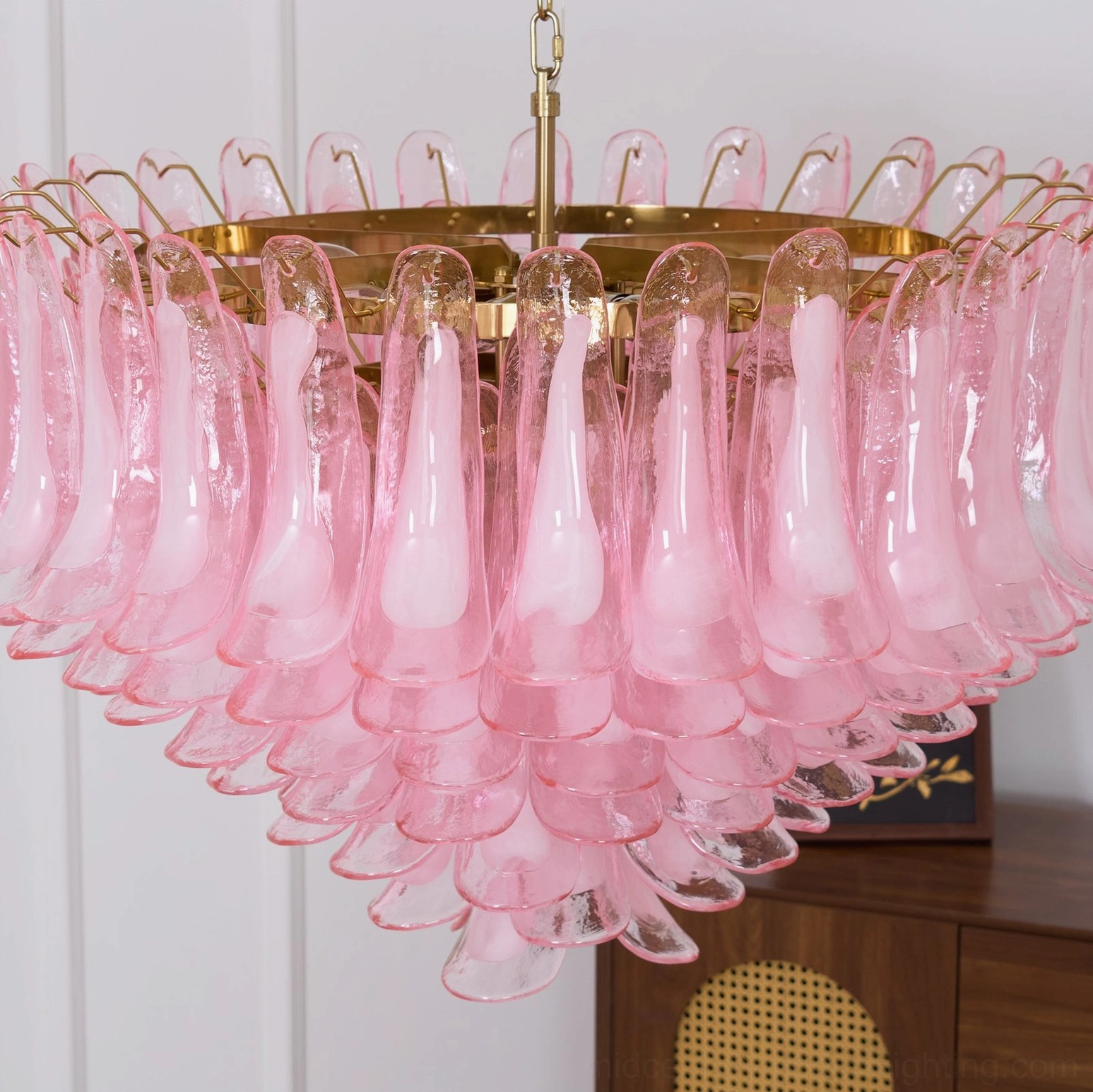 Pink Murano glass chandelier installed in high-ceiling residential space demonstrating dramatic focal point impact