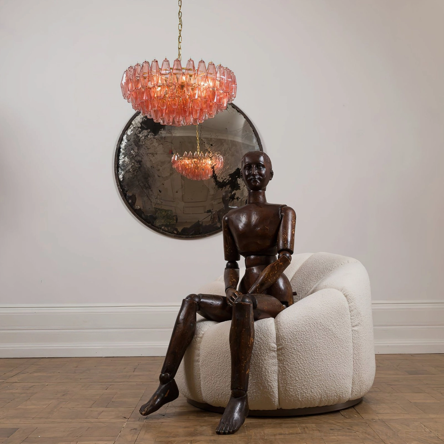 Pink polygon glass chandelier architectural lighting design showing faceted glass geometry and light refraction