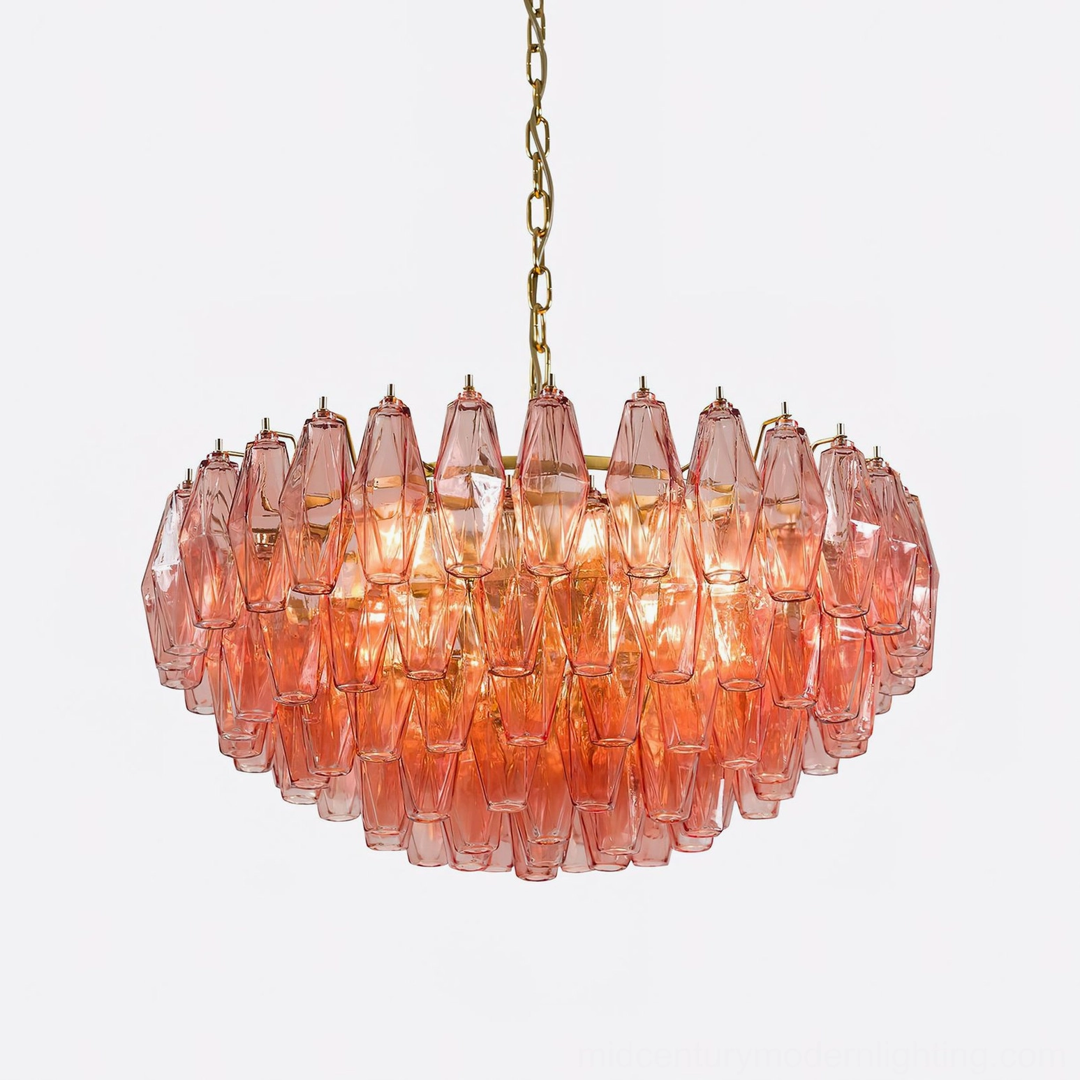 Illuminated pink polygon glass chandelier glowing warmly with detailed layered glass arrangement and geometric facets