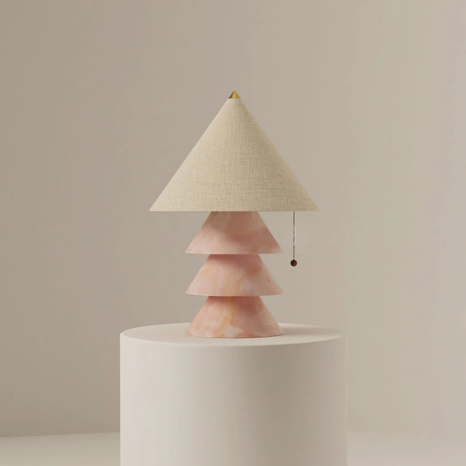 Pink marble pyramid table lamp with beige fabric shade and pull cord on neutral studio background