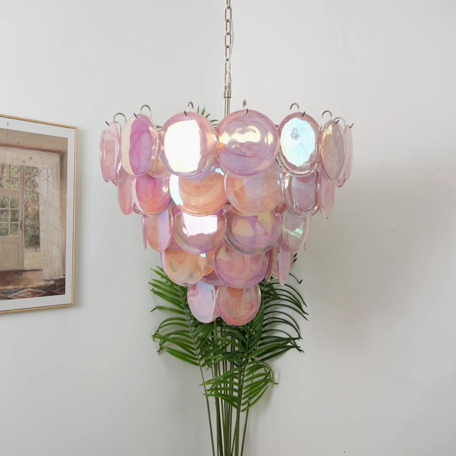 Pink gradient glass disc chandelier with romantic watercolor effect, home setting three-quarter view showcasing tiered conical shape