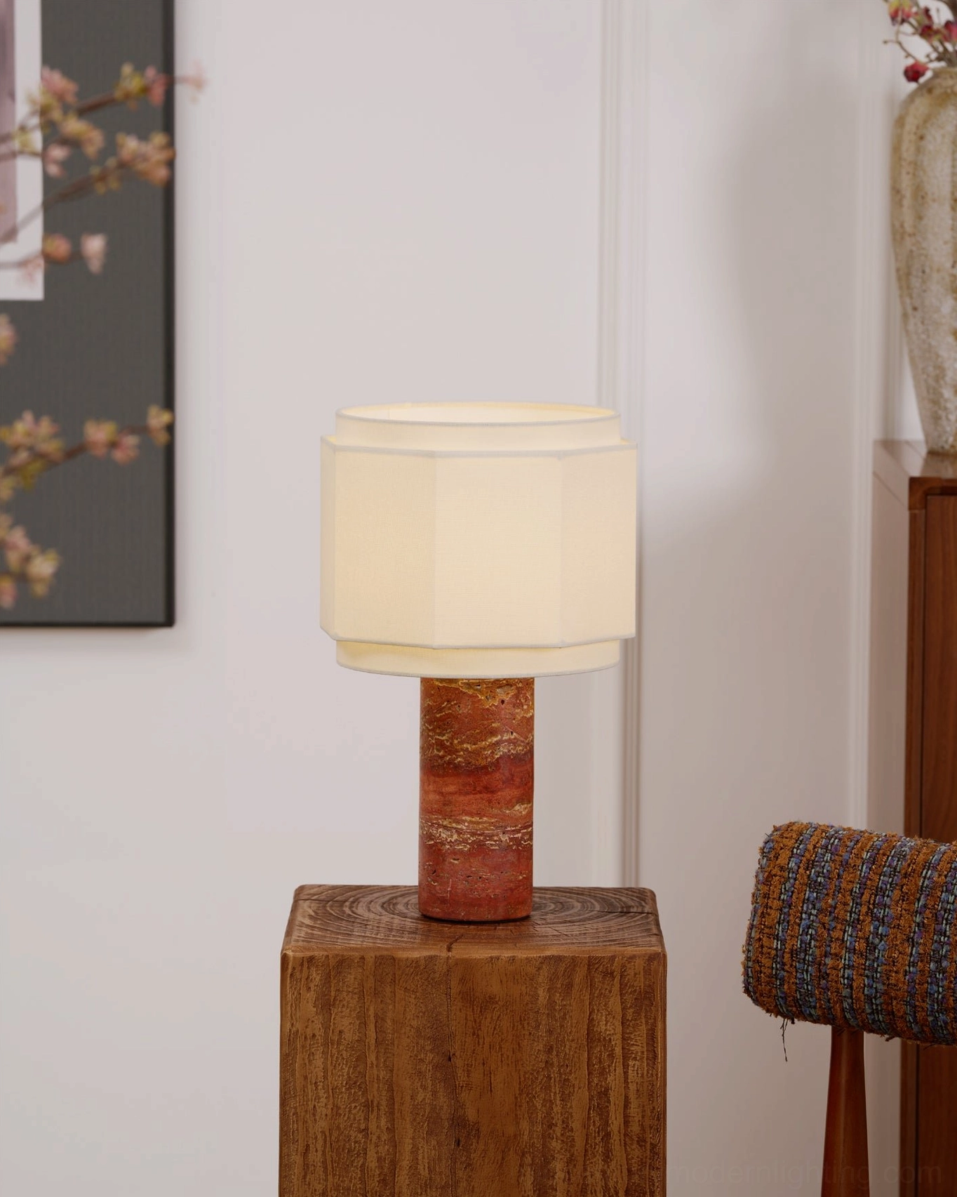Pipito stone base lamp creating soft warm glow in modern home office or study corner