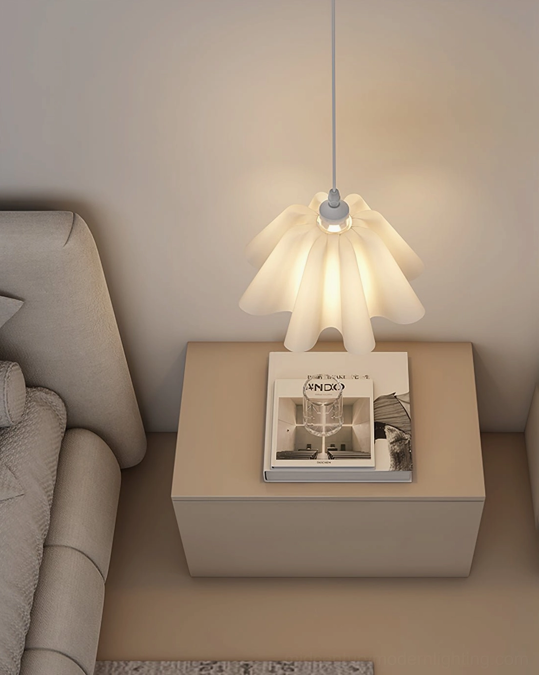 Sculptural white pleated pendant suspended in living room creating creamy minimalist design focal point